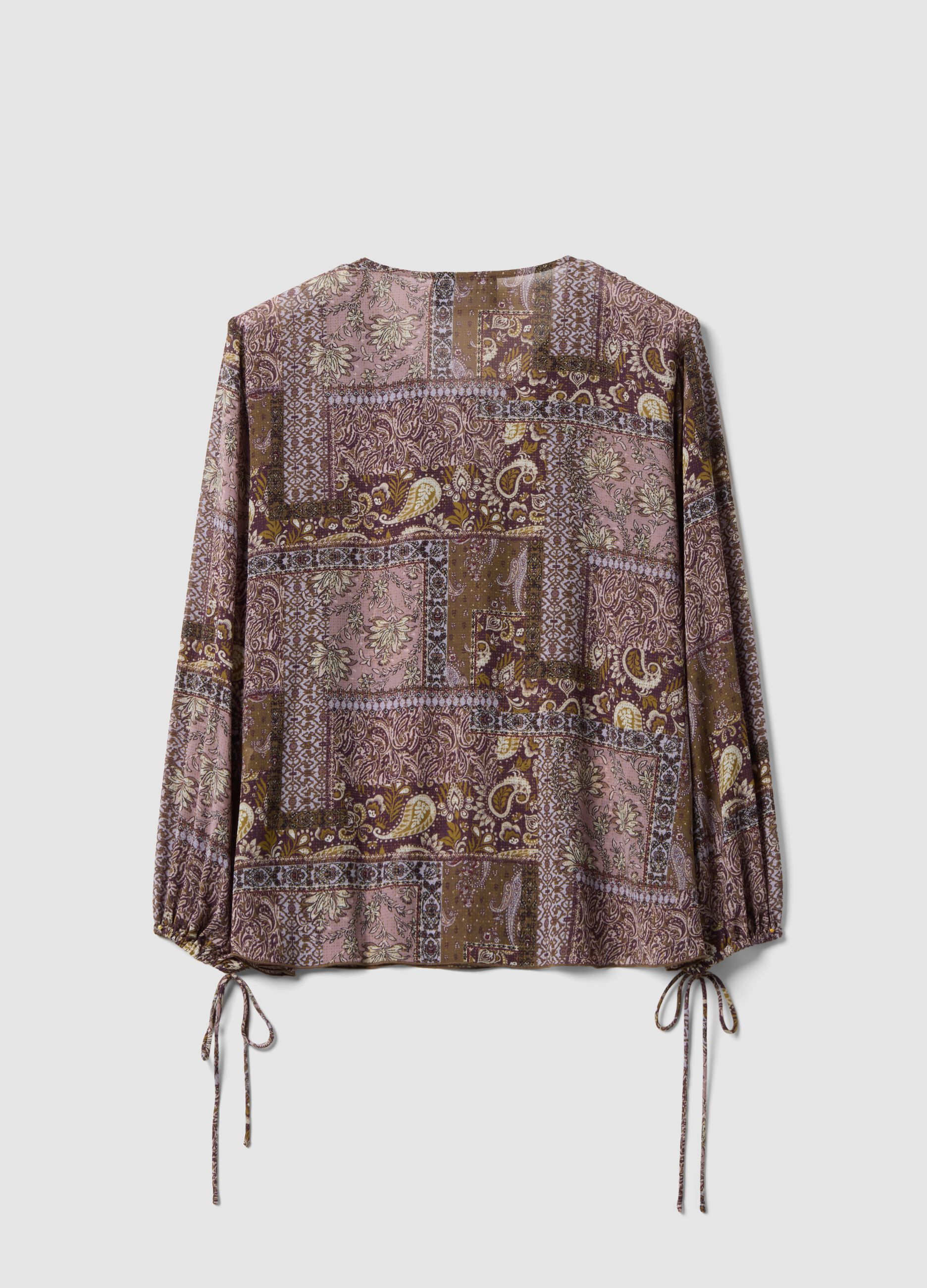 Purple patterned blouse with ruffles and tie neck