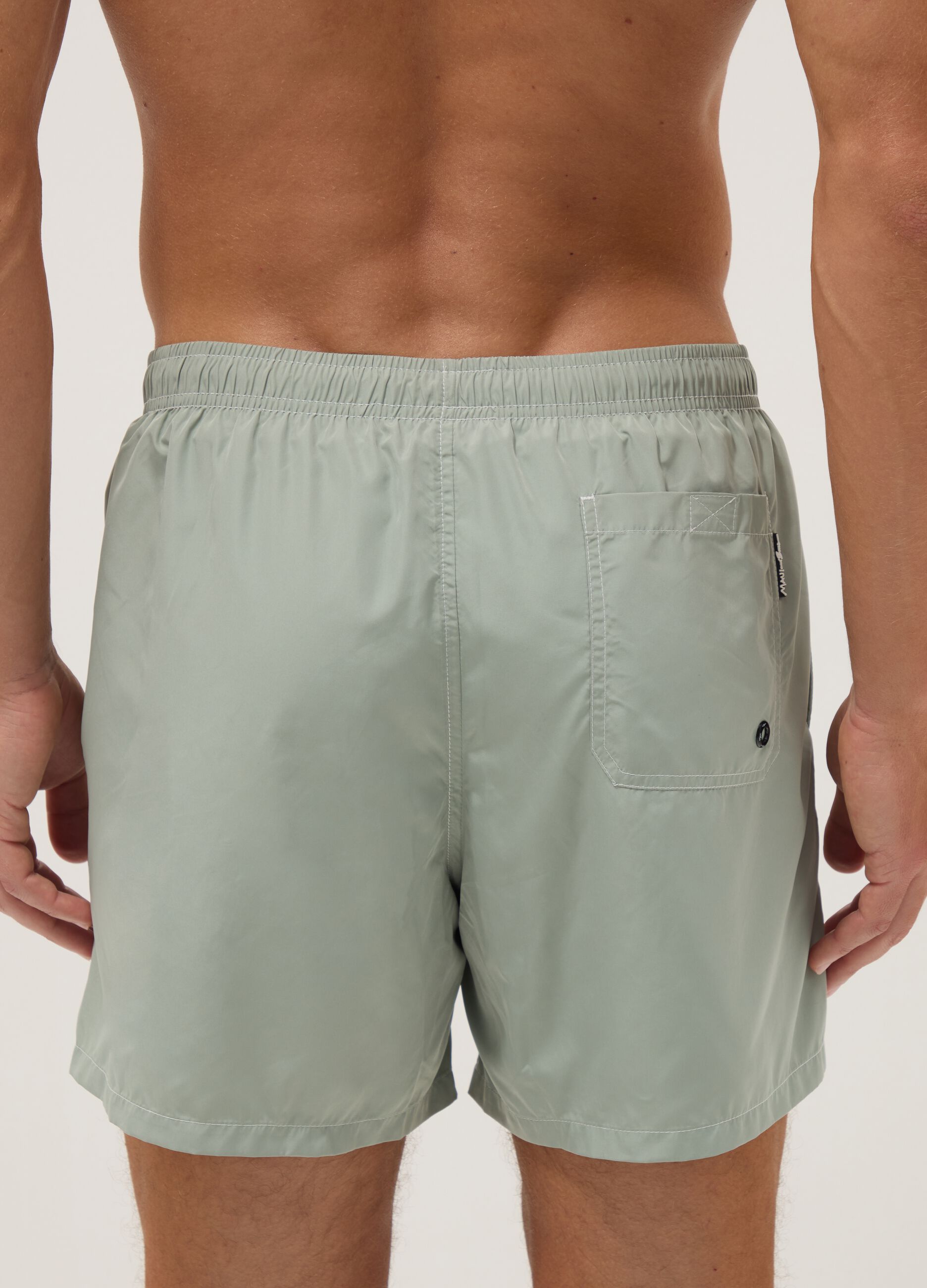 Green swim shorts with elasticated waistband and drawstring