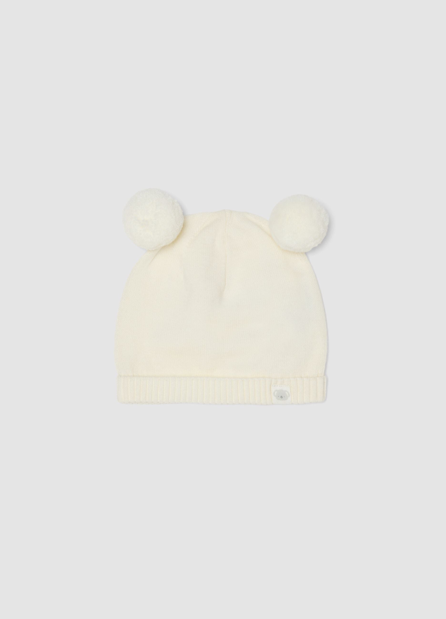 Weisse Baby-M&uuml;tze aus reiner Bio-Baumwolle, gestrickt, mit Pompons