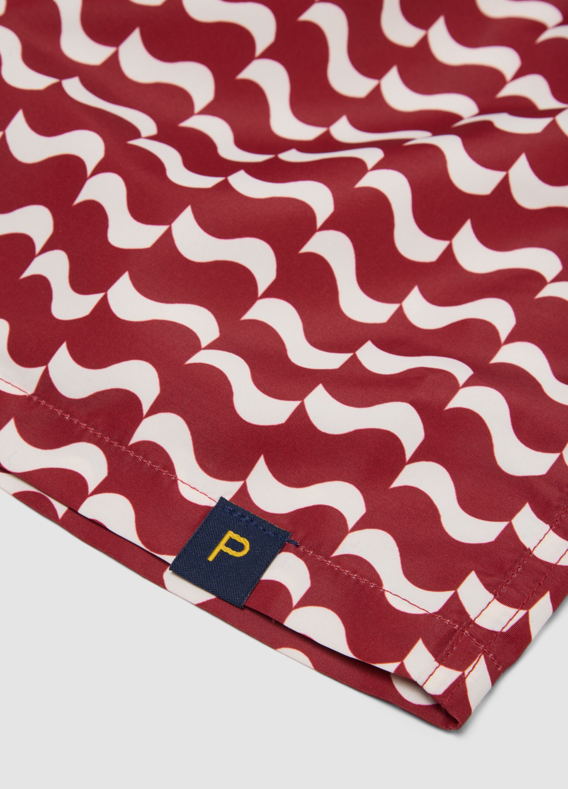 Red men&rsquo;s swim shorts with all-over print