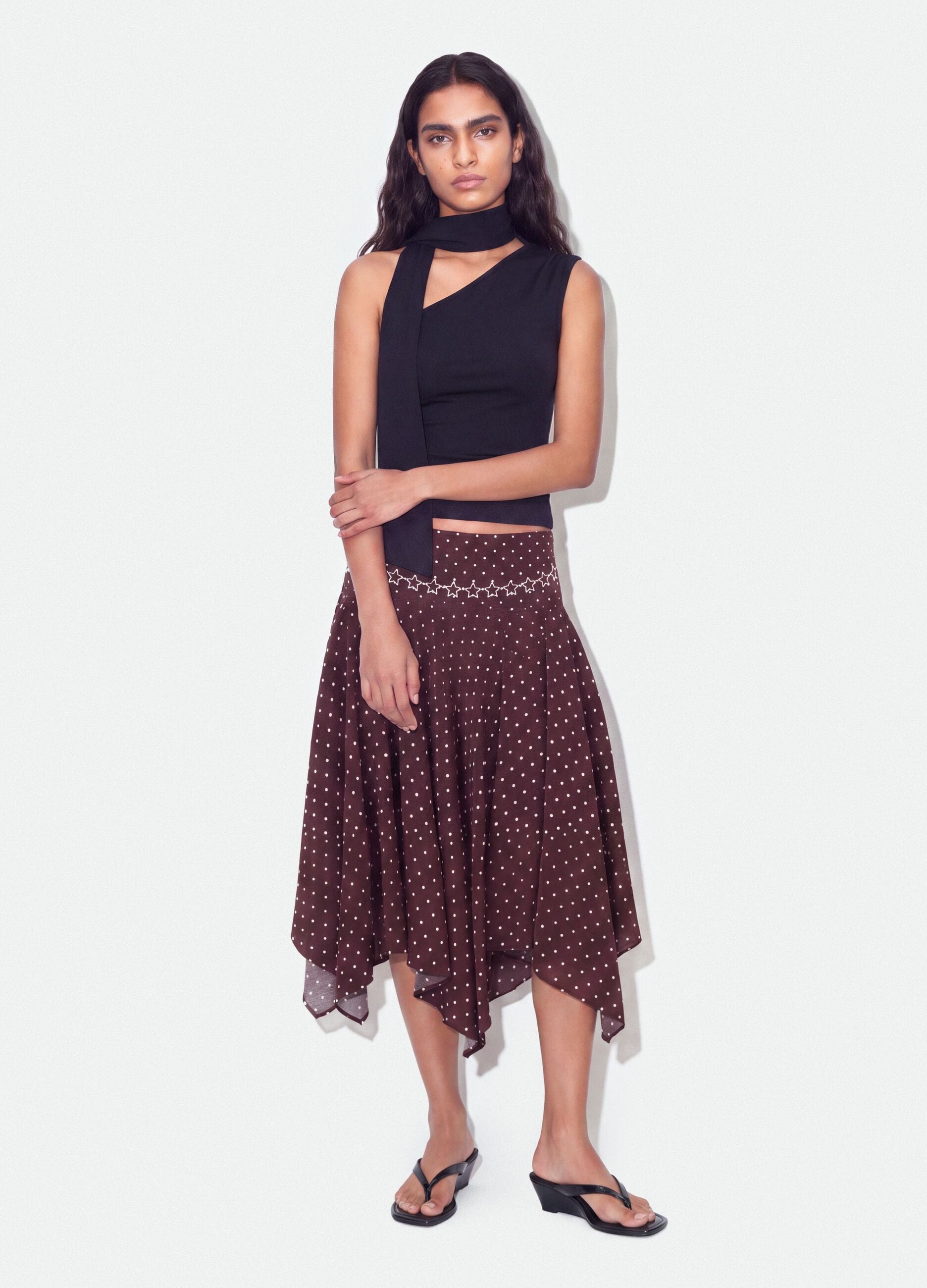 Black stretch top with asymmetric neckline and draped band