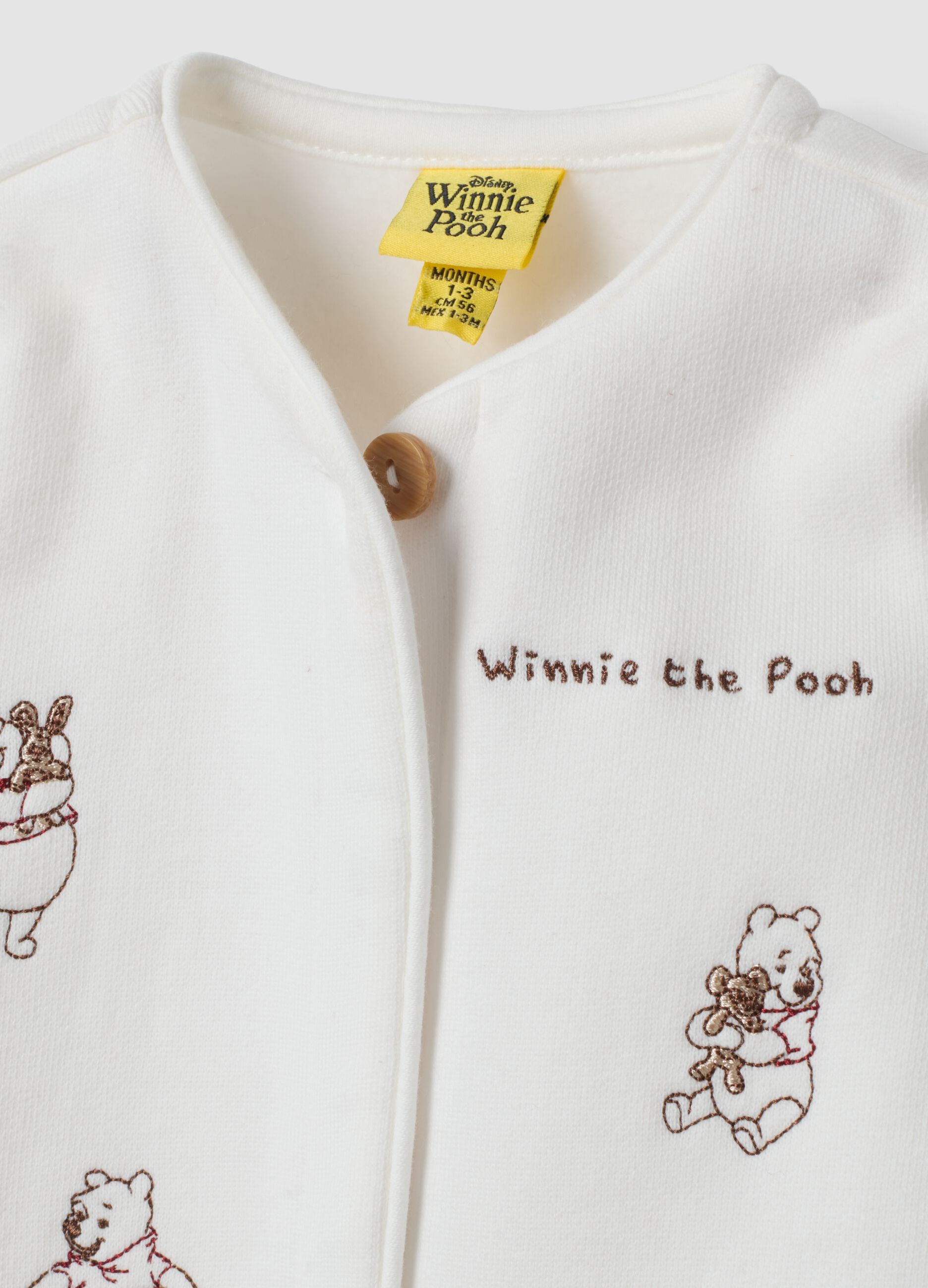 Off-white organic cotton sleepsuit with Winnie the Pooh print