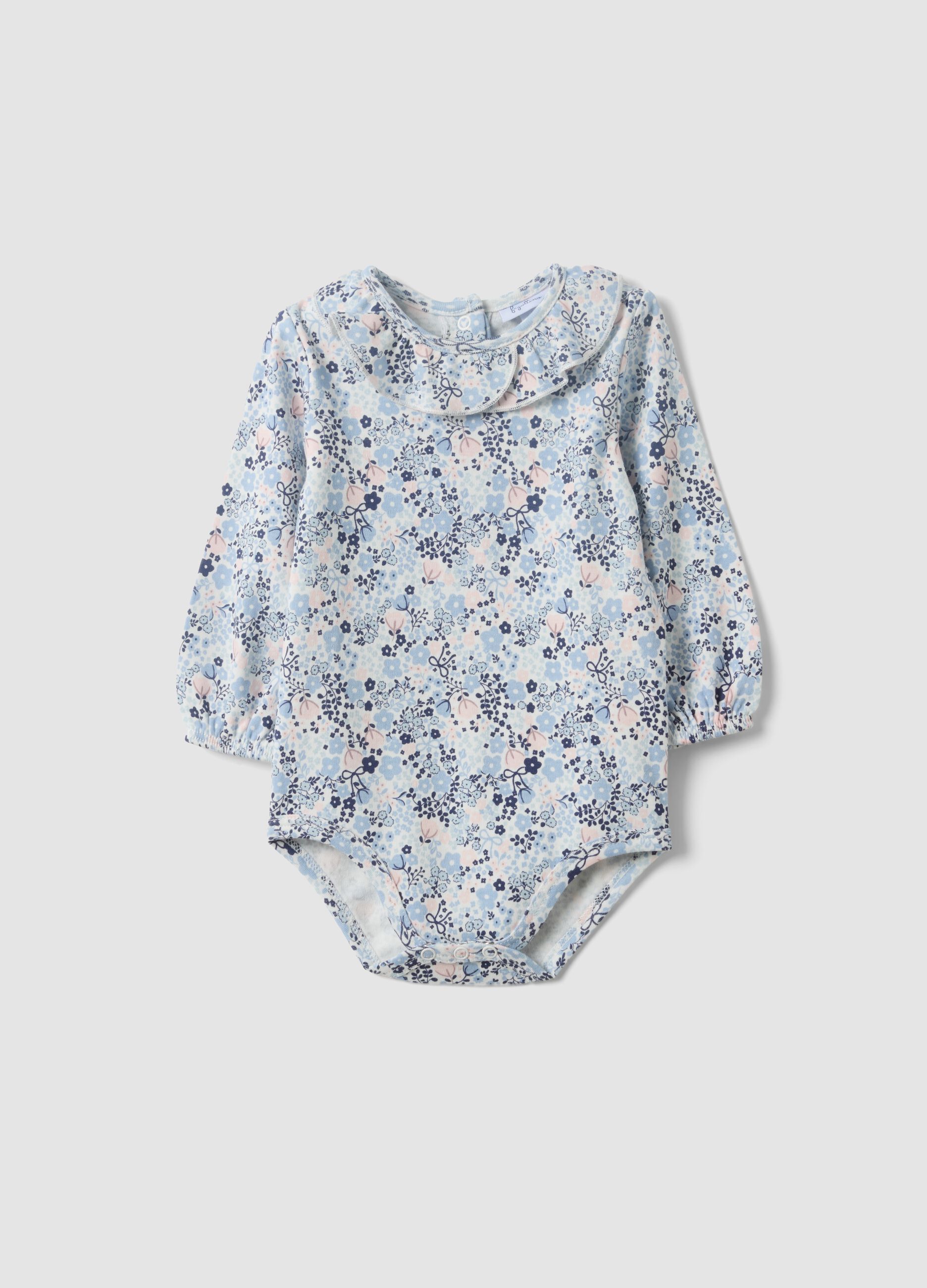 Body branco de algod&atilde;o org&acirc;nico para beb&eacute; menina com gola com folhos e estampado floral