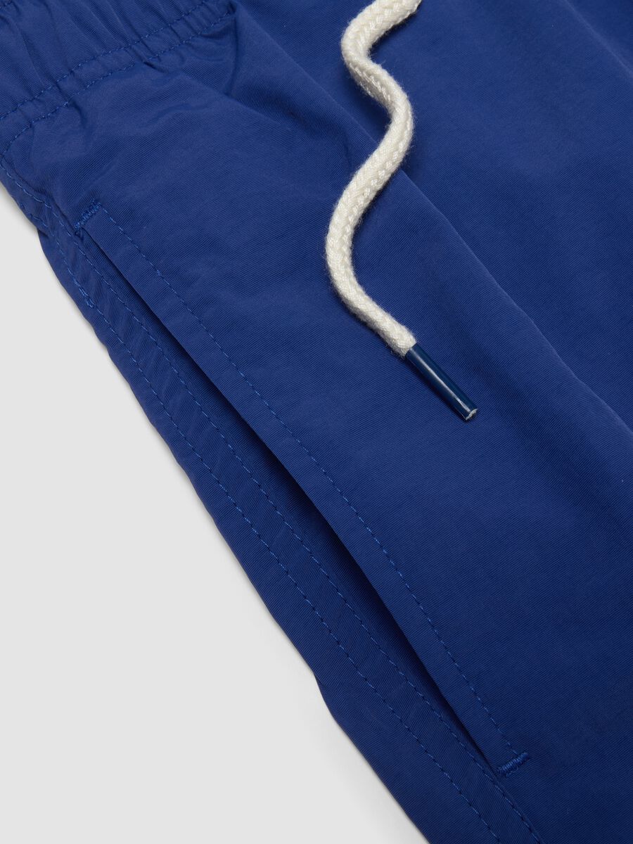 Blue swim shorts with elasticated waist and drawstring_5