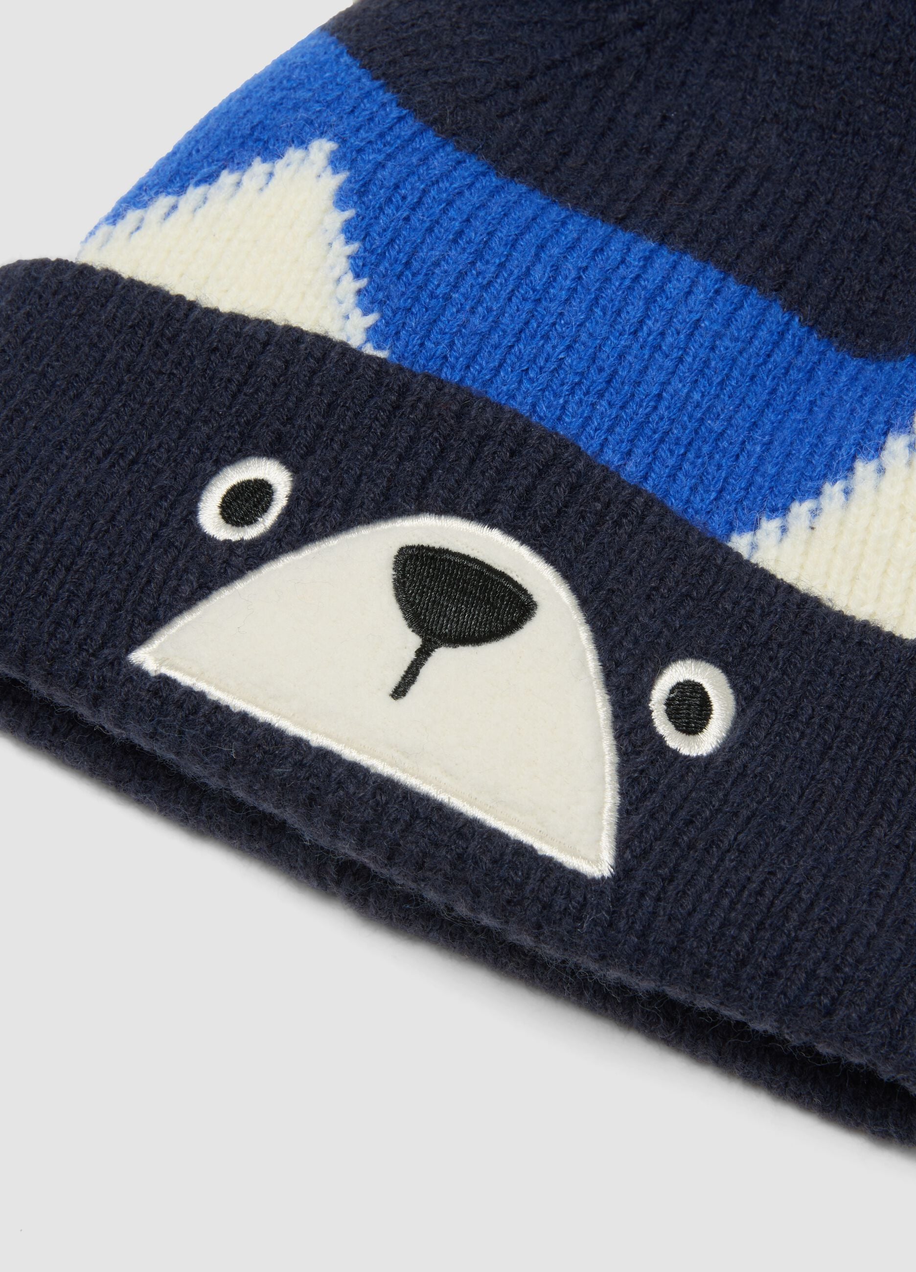 Gorro azul de malha com pompom e motivo animal