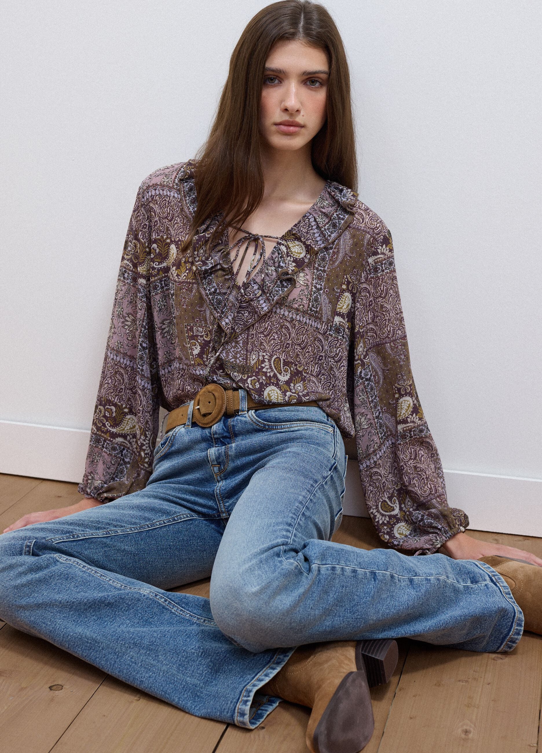Purple patterned blouse with ruffles and tie neck