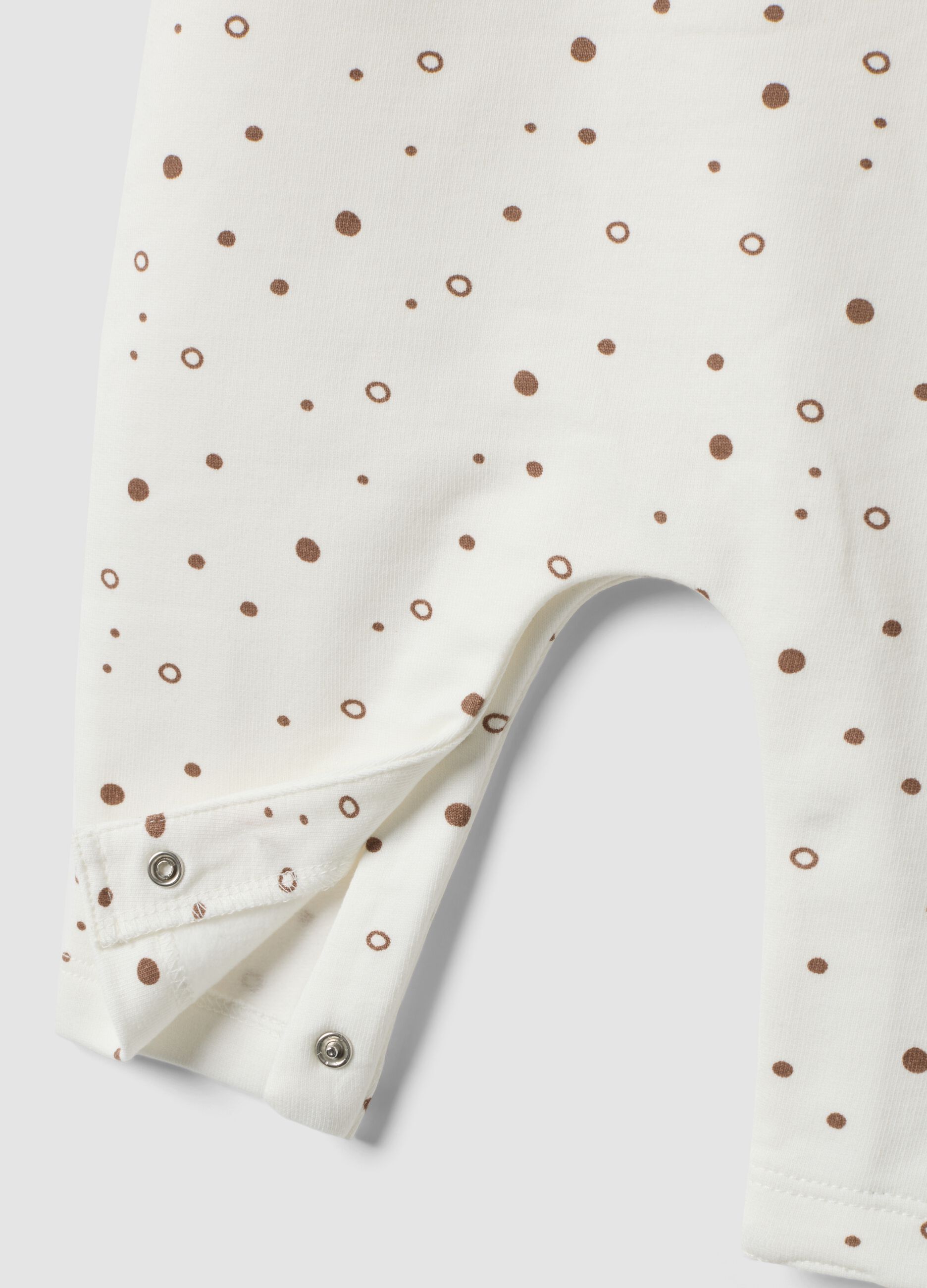 Babygrow branco em algod&atilde;o org&acirc;nico puro &agrave;s bolinhas