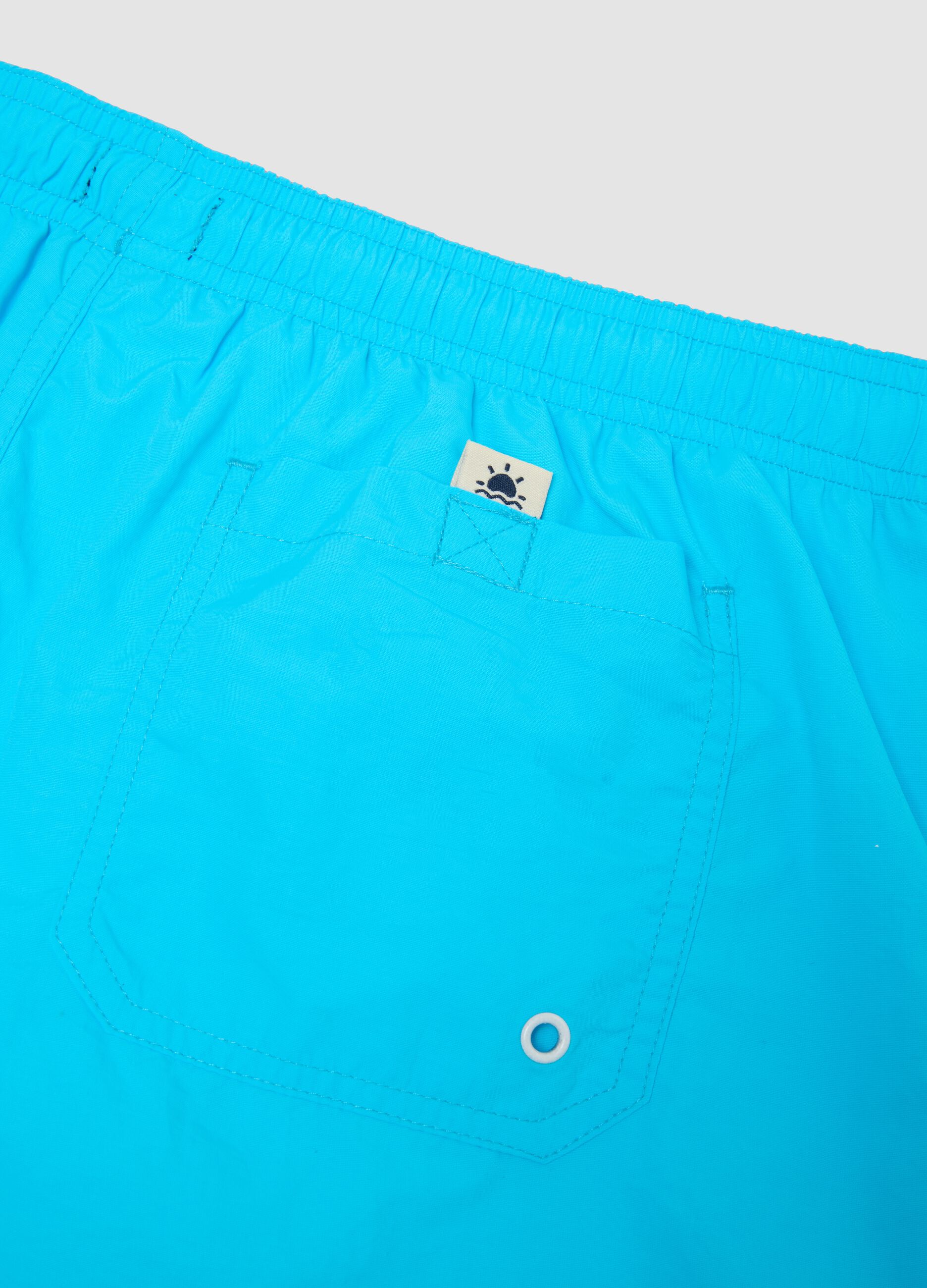 Blue swim shorts with elasticated waist