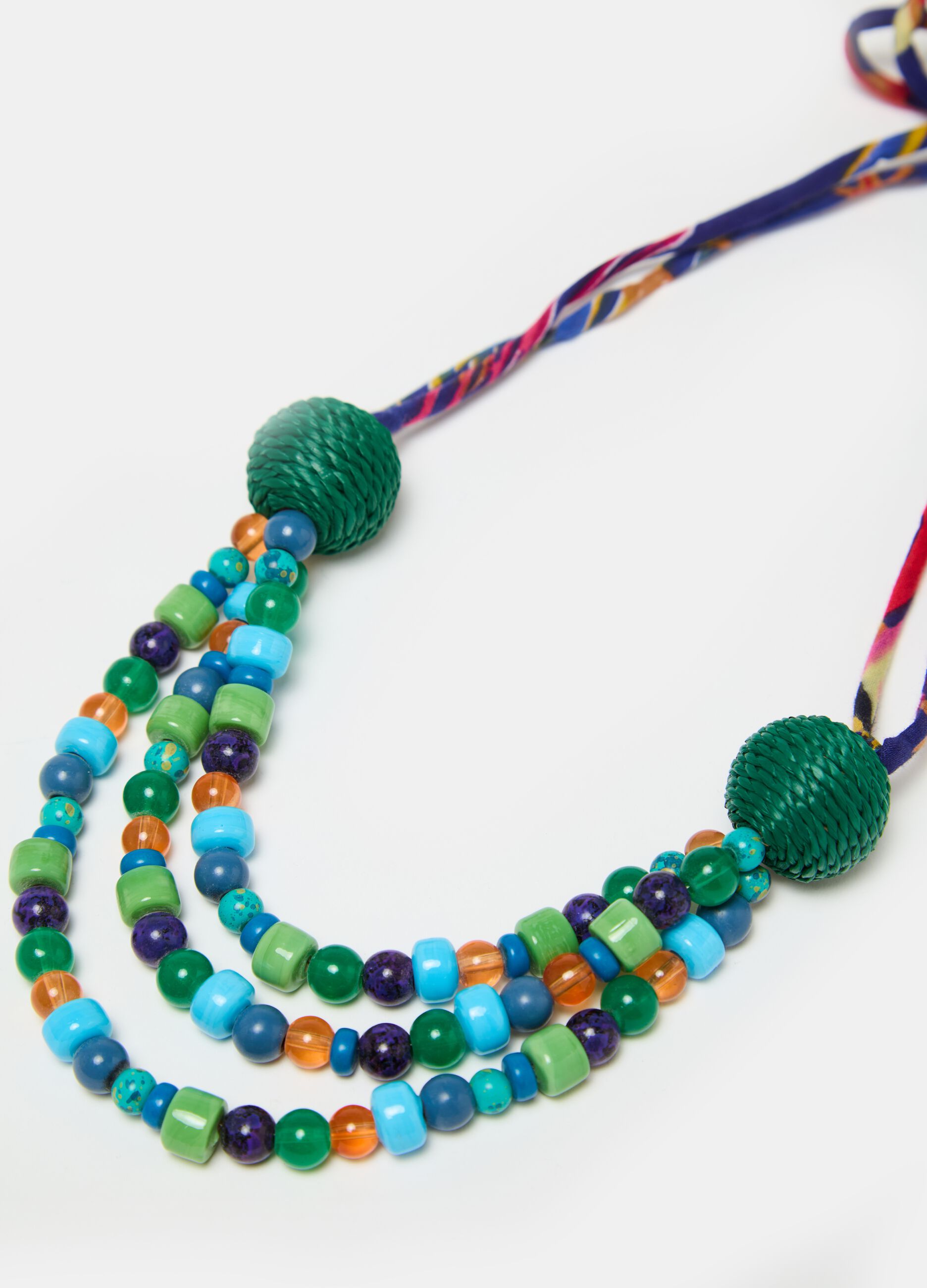 Necklace with coloured gems and laces