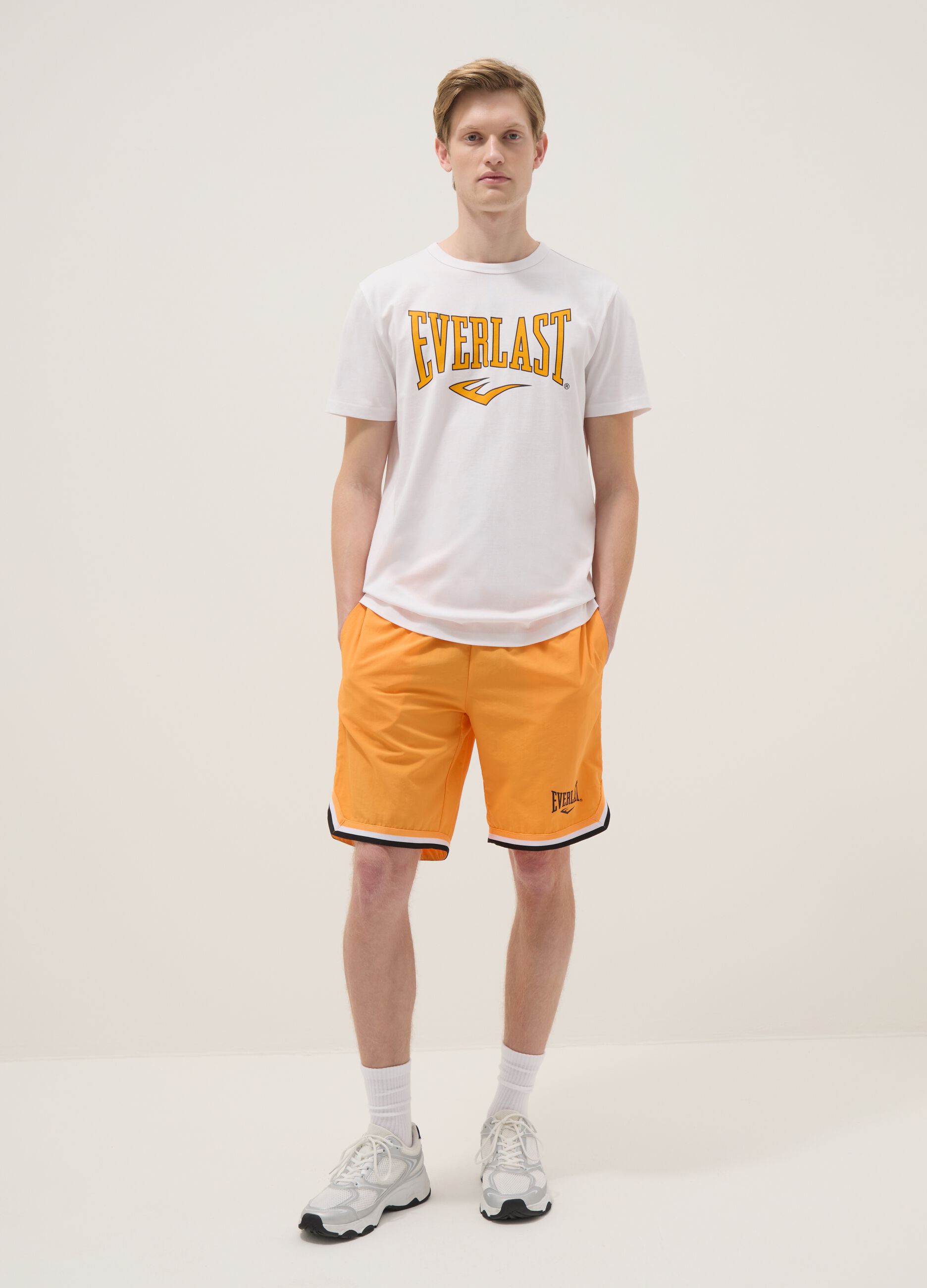 Orange regular fit sports shorts with white and black details