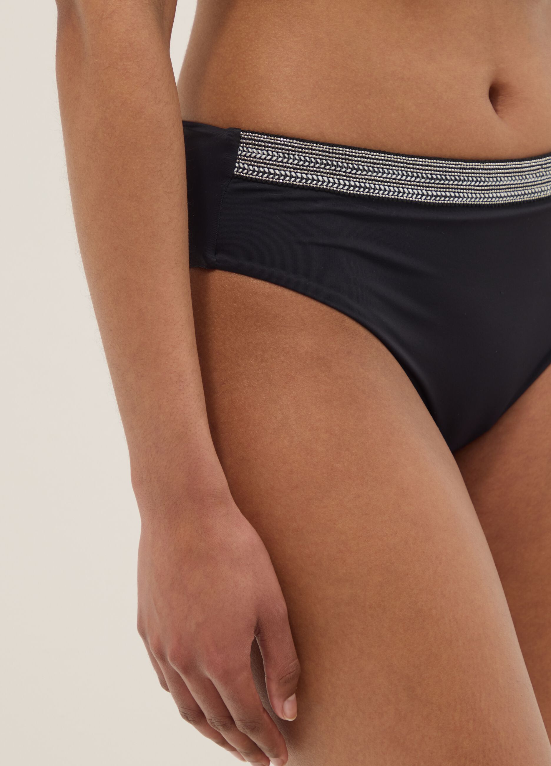 Black stretch swim briefs with embroidered details