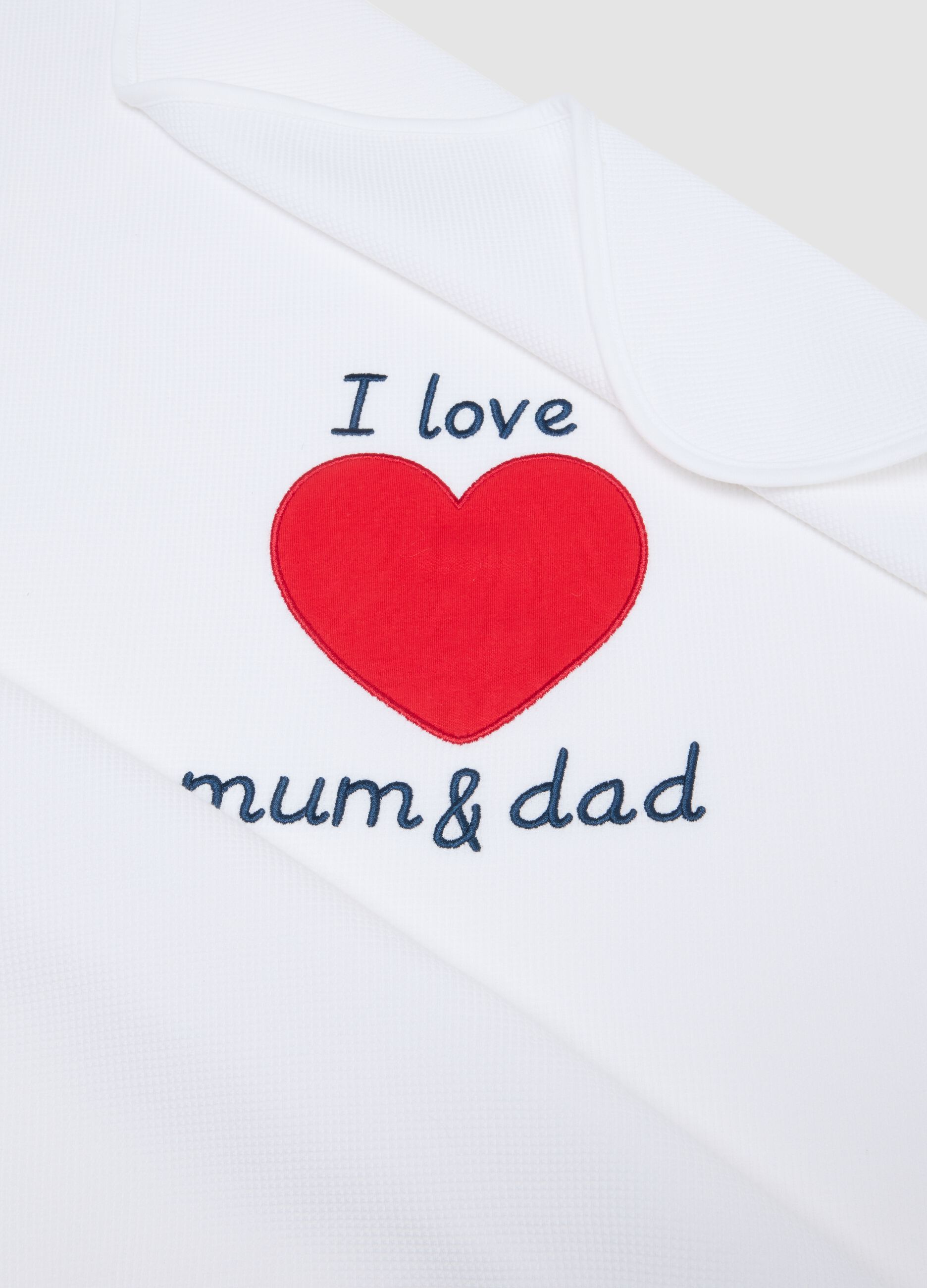 White 100% cotton baby blanket with red heart