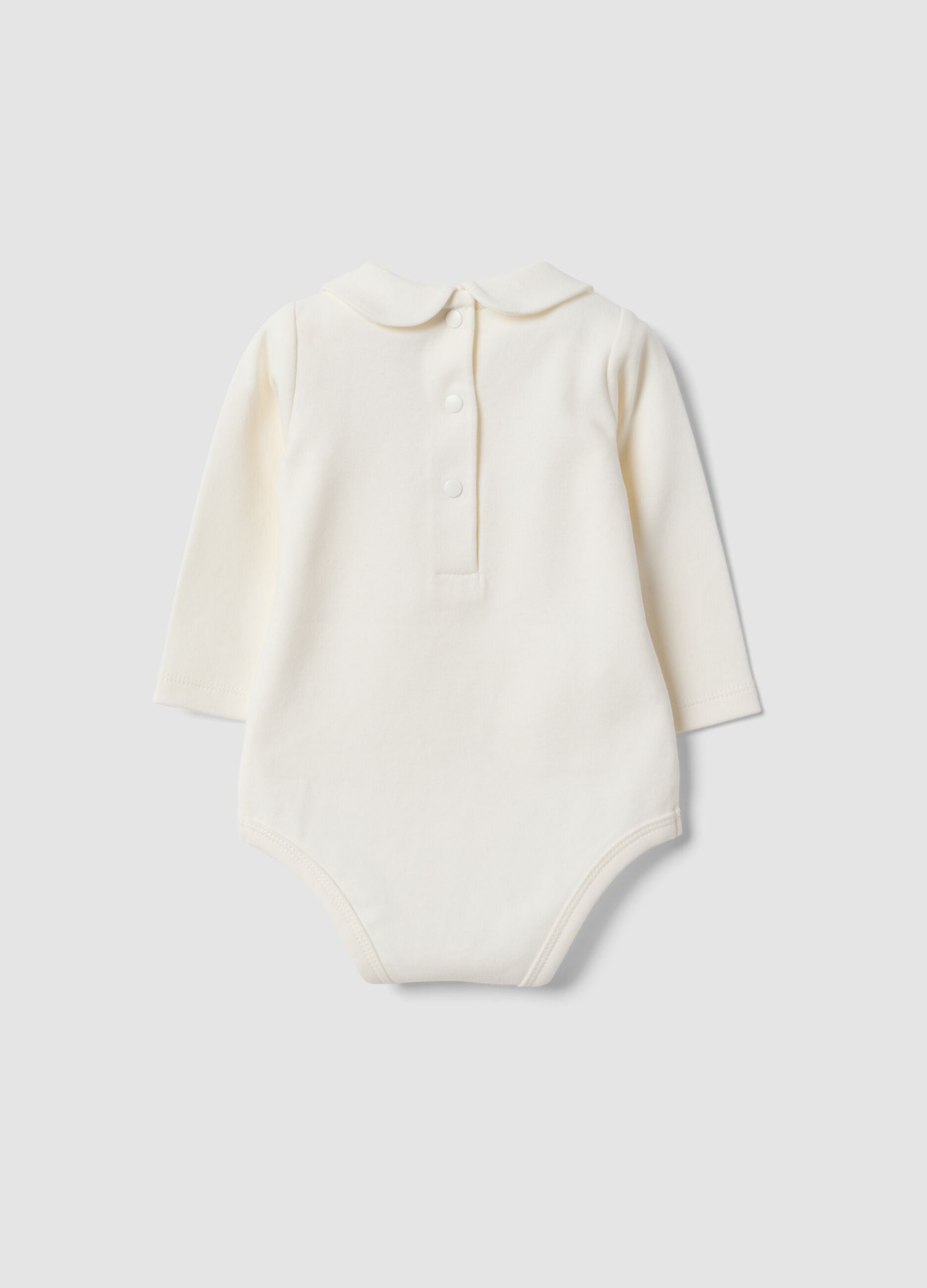 Body bianco in puro cotone organico con ricami floreali per neonata