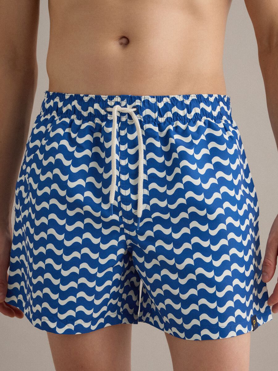 Blue swim shorts with wave pattern_2