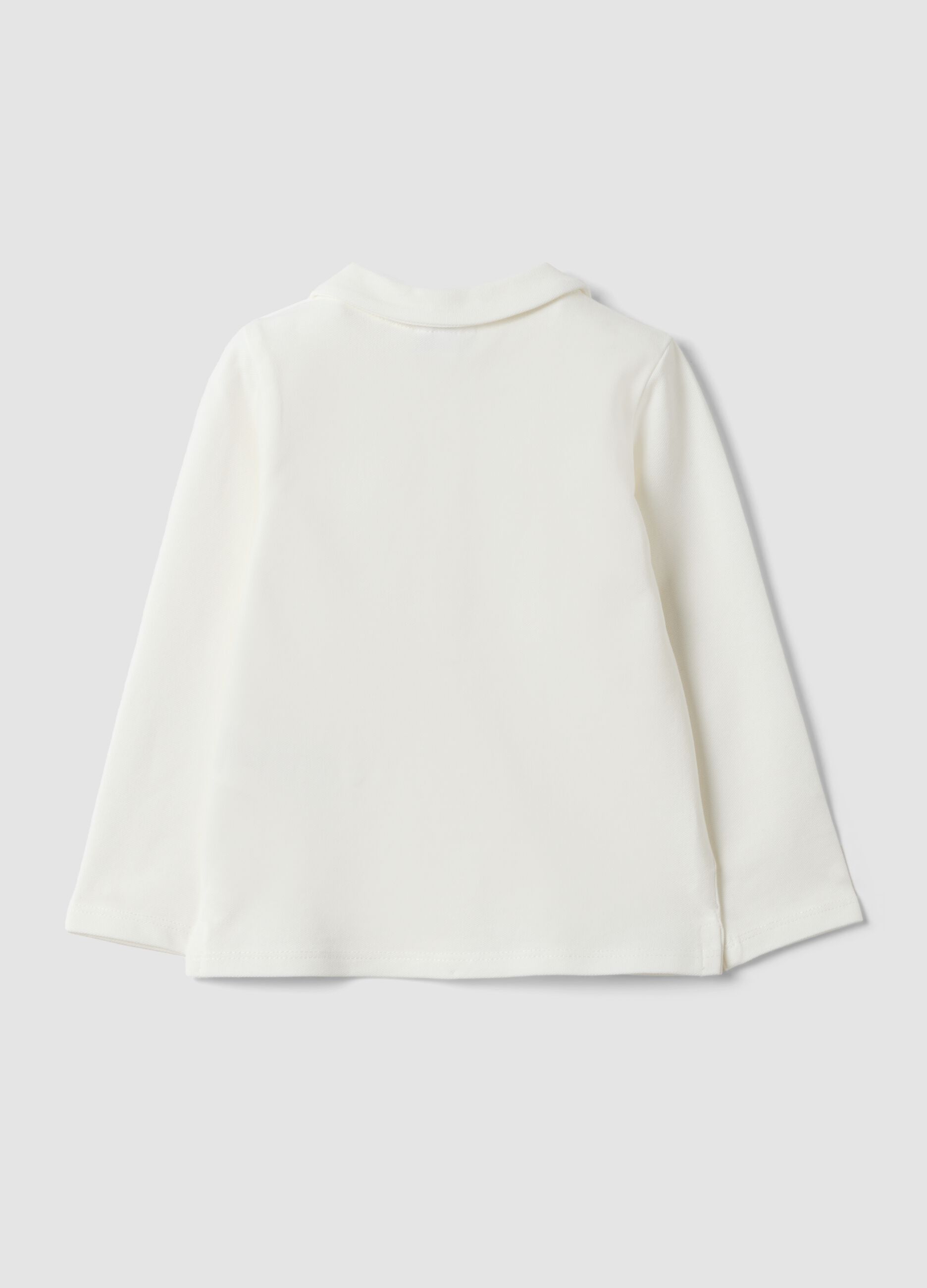 Polo bianca in cotone organico elasticizzato con dettagli volant per bimba