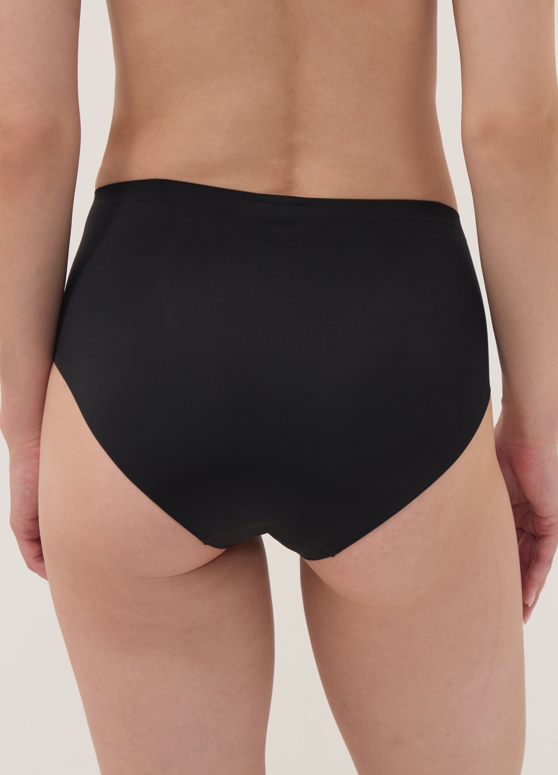 Black high-waisted Brazilian briefs in stretch fabric with a shaping effect