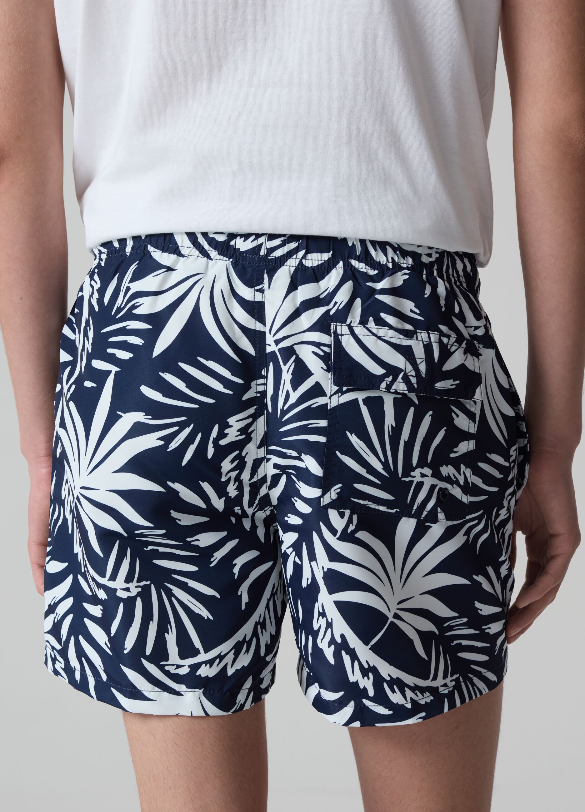 Bermuda swim shorts with foliage print