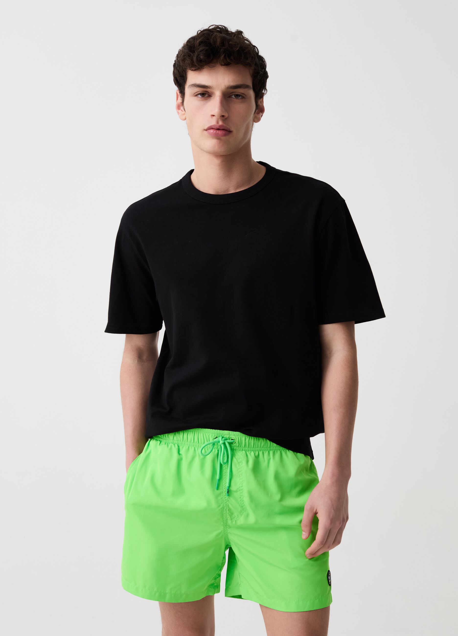 Fluorescent swimming trunks with logo patch