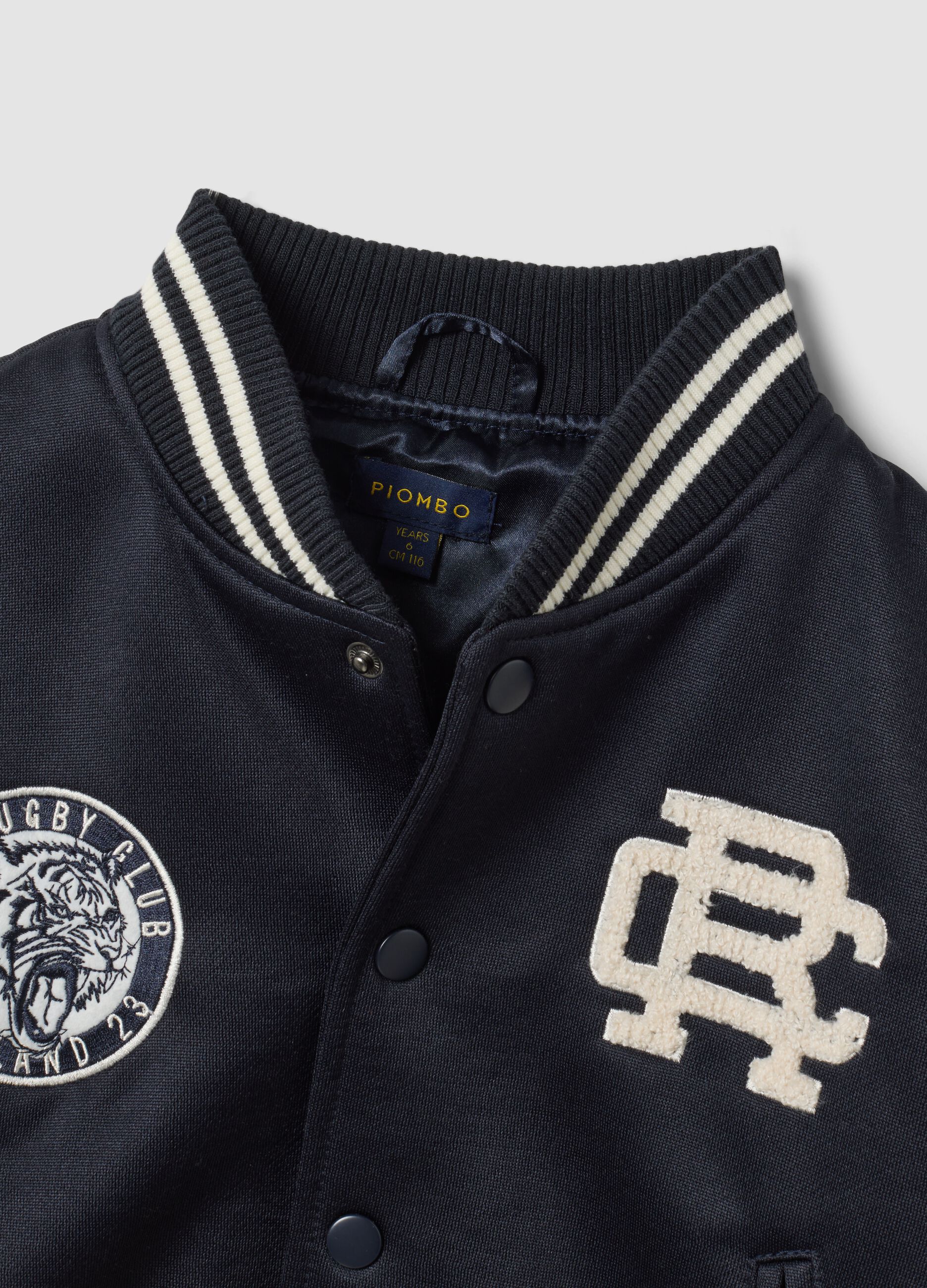 Blue varsity jacket with beige sleeves and print for boys