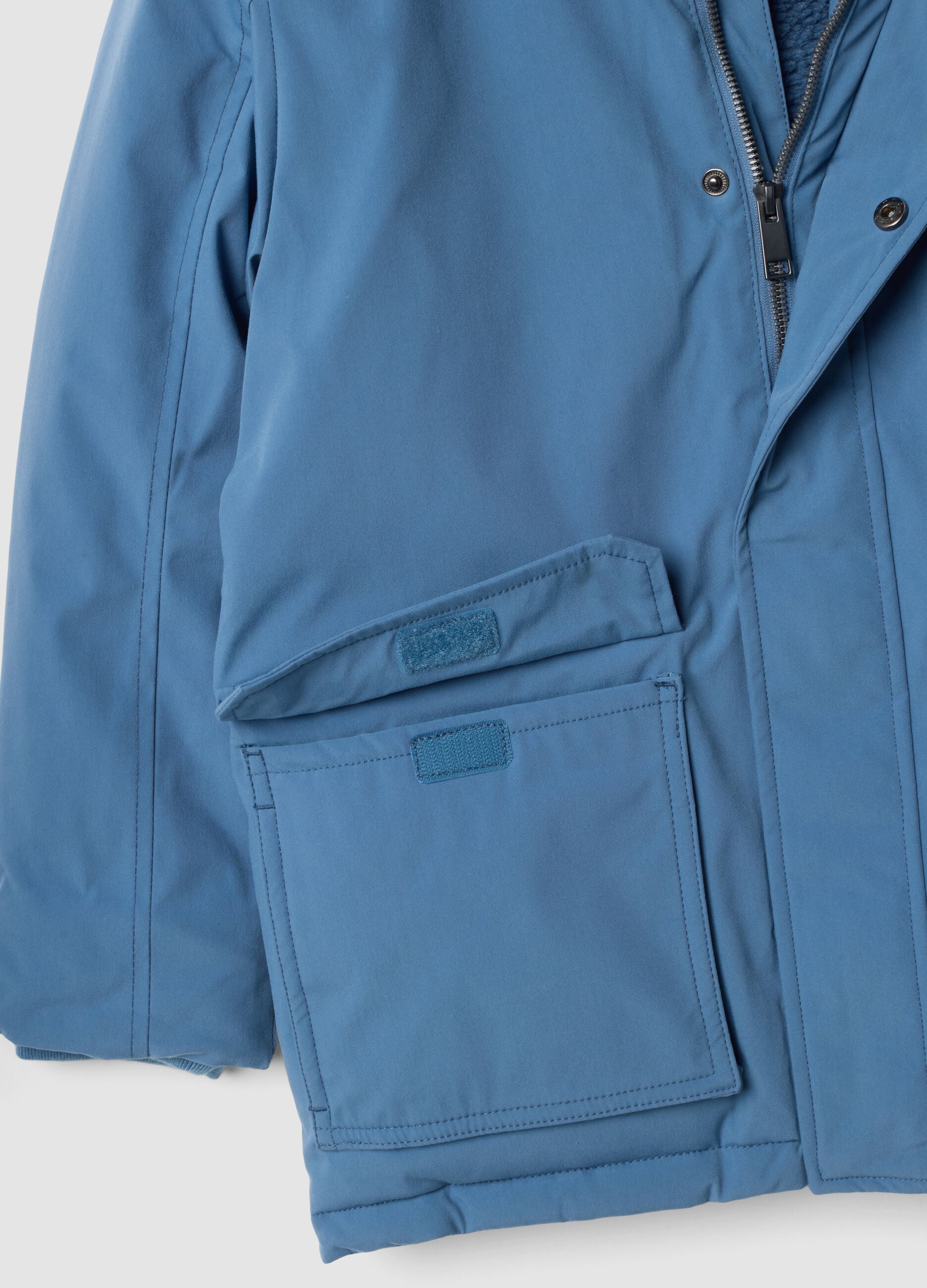 Long padded blue parka with detachable hood, oversized fit