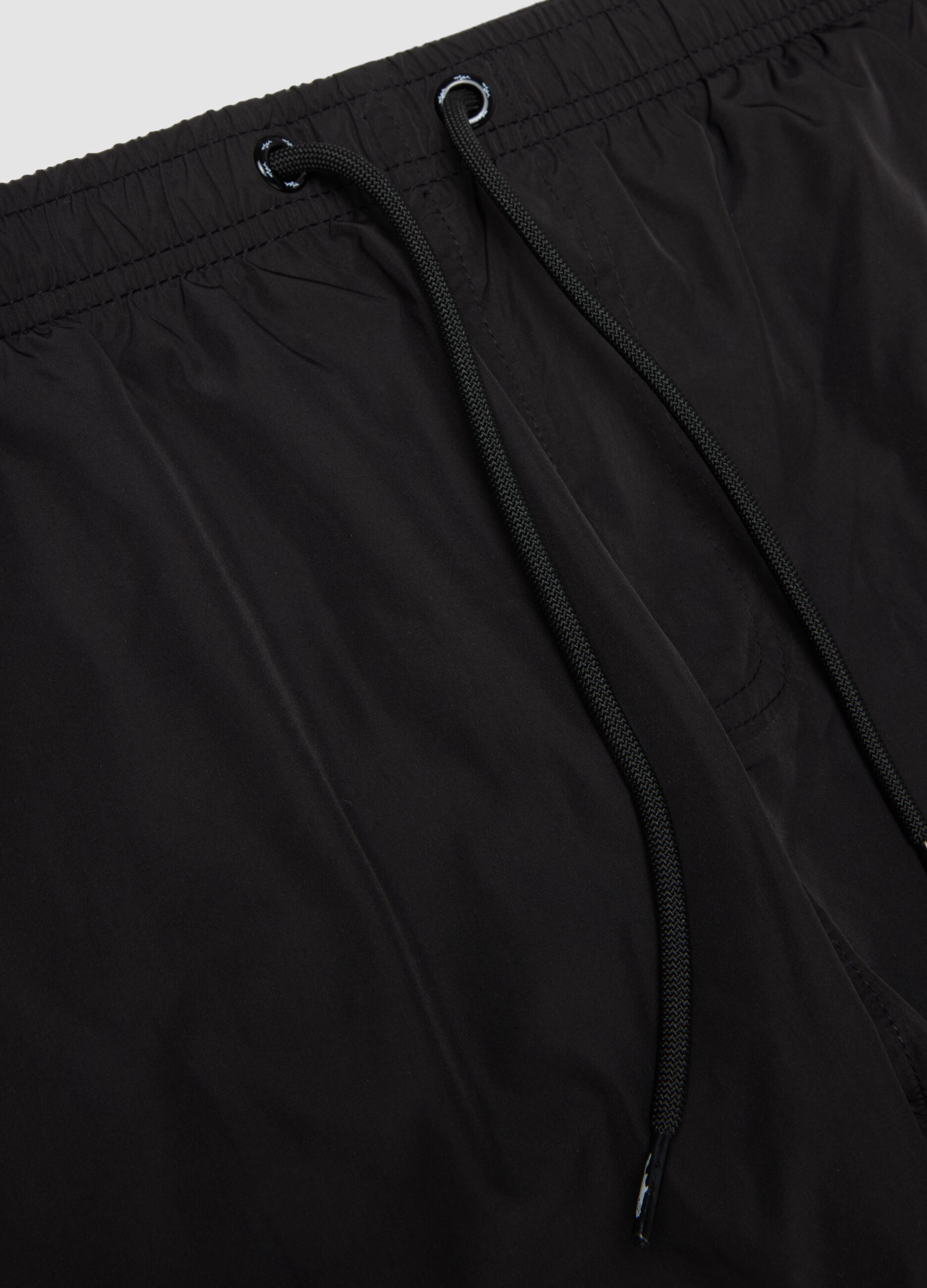 Black swim shorts with elasticated waistband