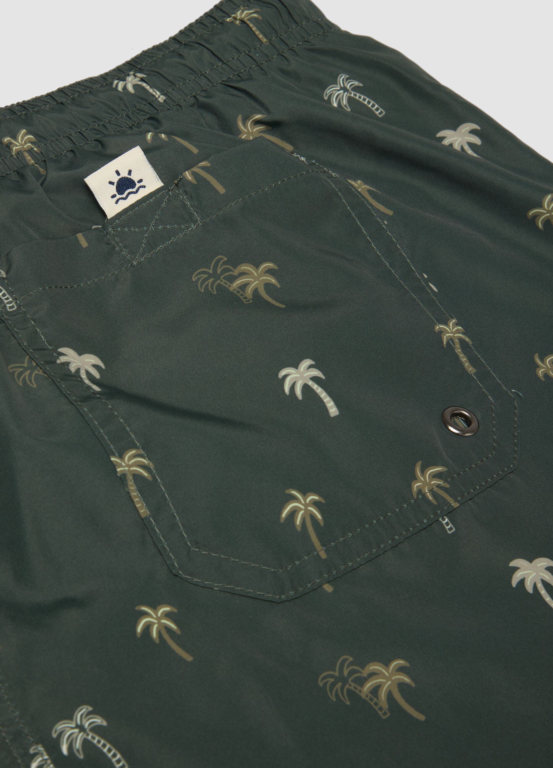 Green boxer swim shorts with palm print