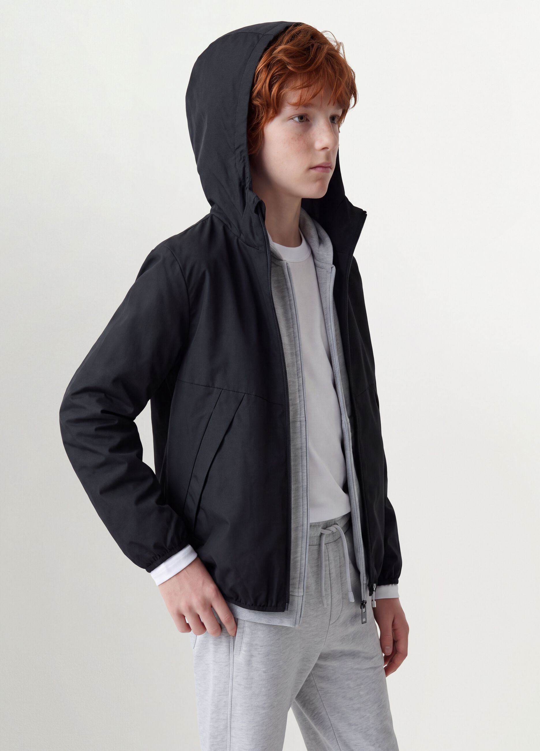 Black oversized rain jacket with hood and zip for boys
