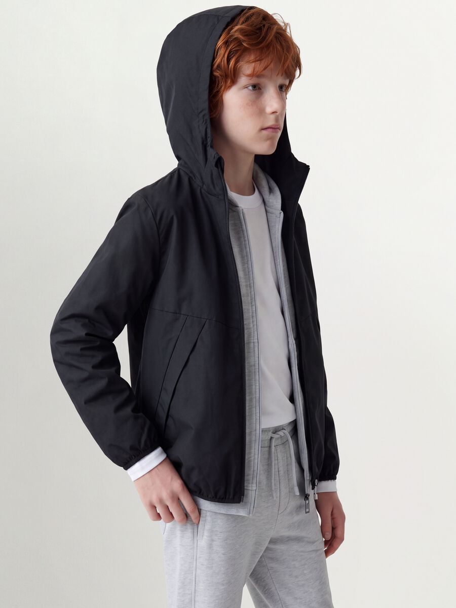 Black oversized rain jacket with hood and zip for boys_0