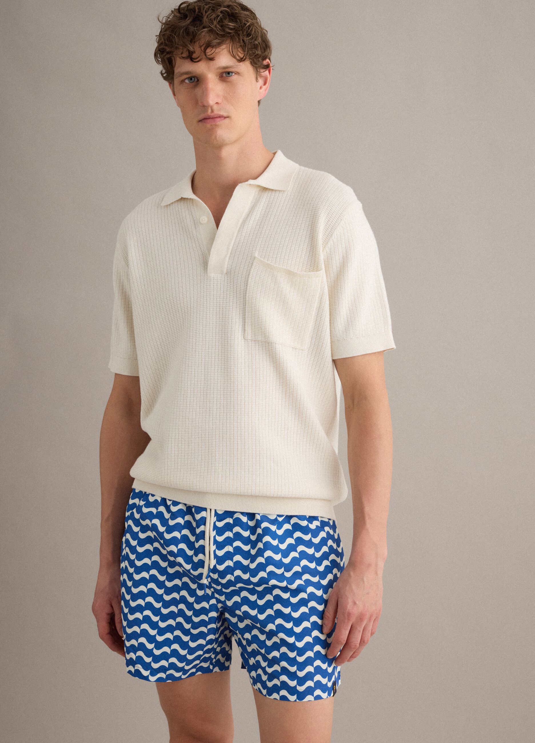 Blue swim shorts with wave pattern