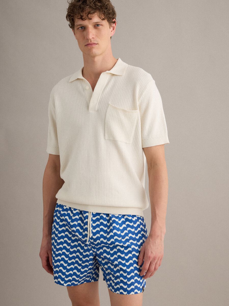 Blue swim shorts with wave pattern_0