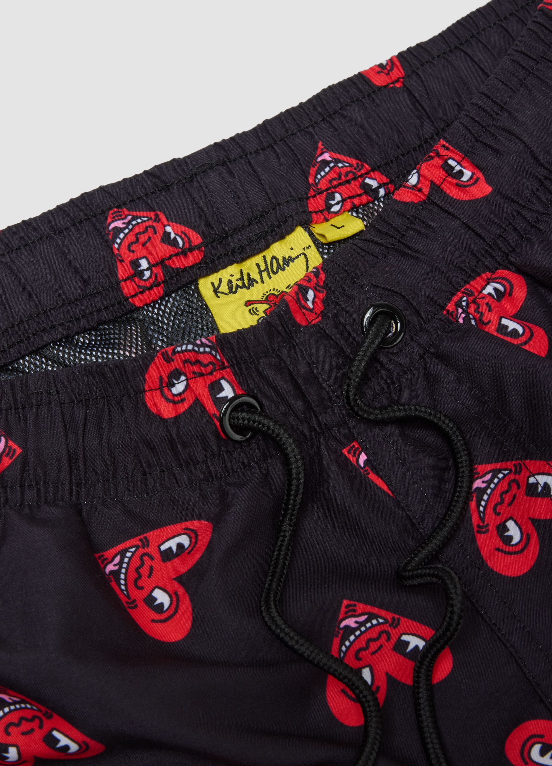 Black beach boxers with Keith Haring heart prints