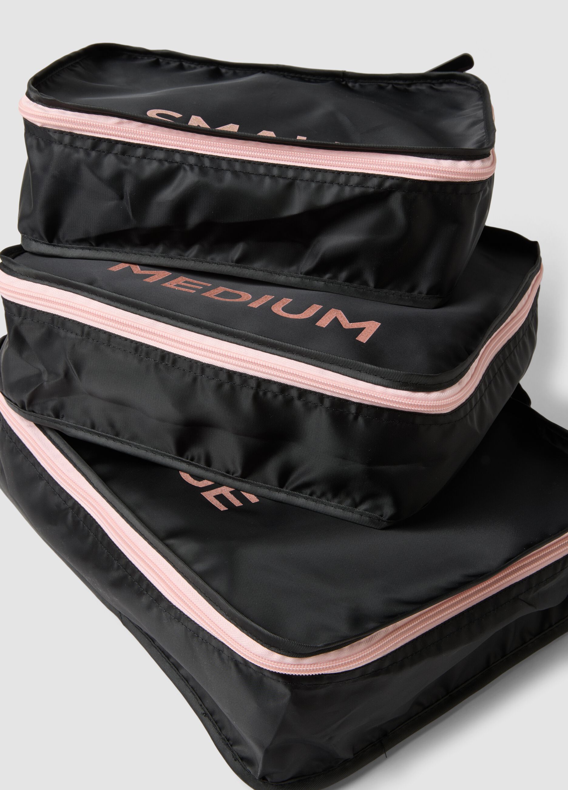 Set di tre organizer neri da viaggio con zip rosa
