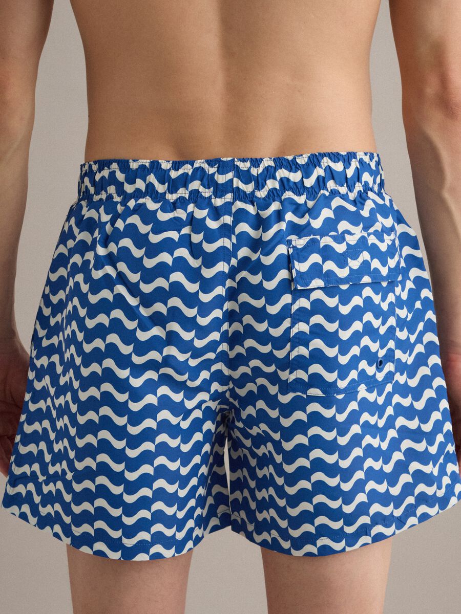 Blue swim shorts with wave pattern_3