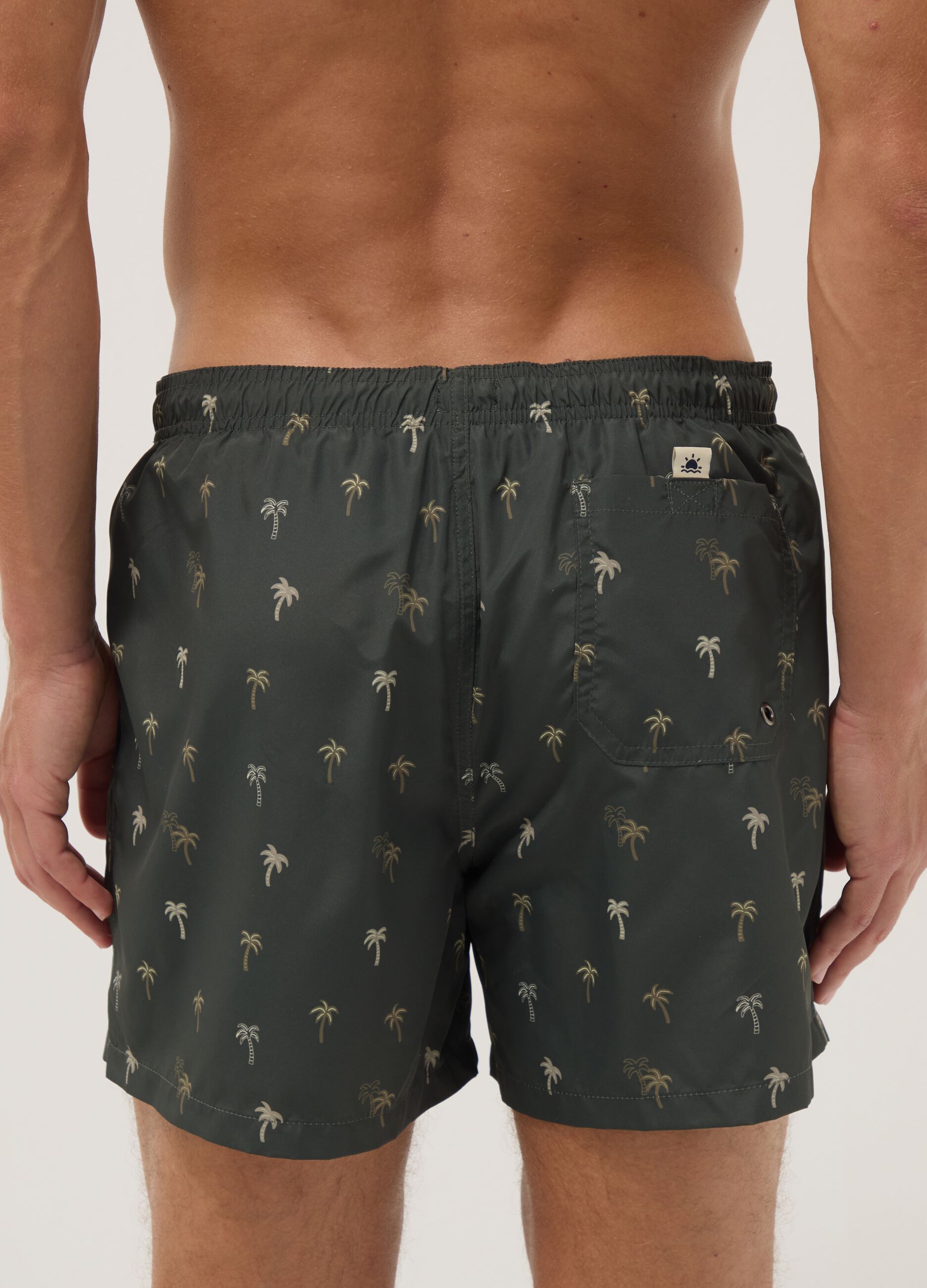 Green boxer swim shorts with palm print