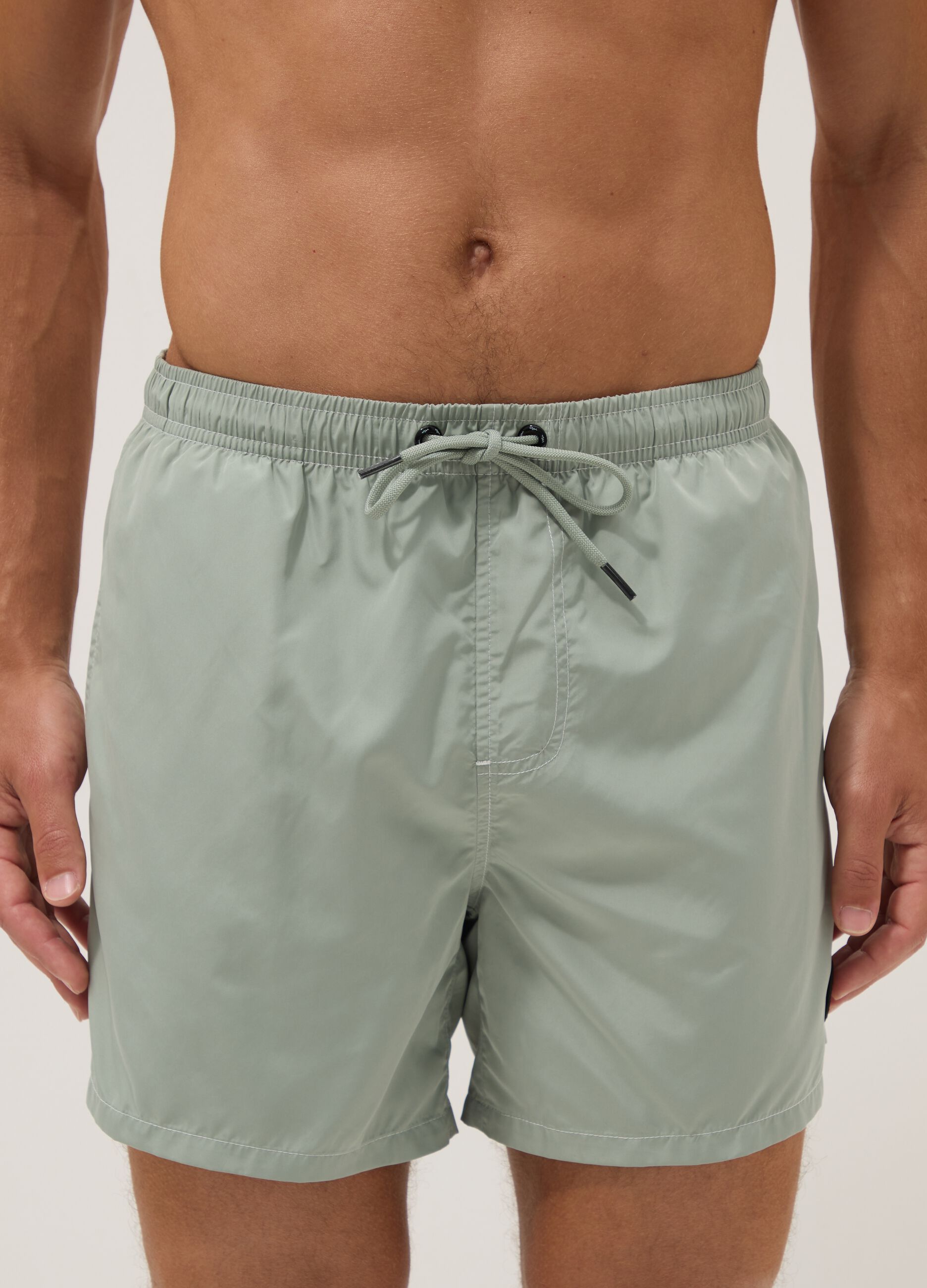 Green swim shorts with elasticated waistband and drawstring