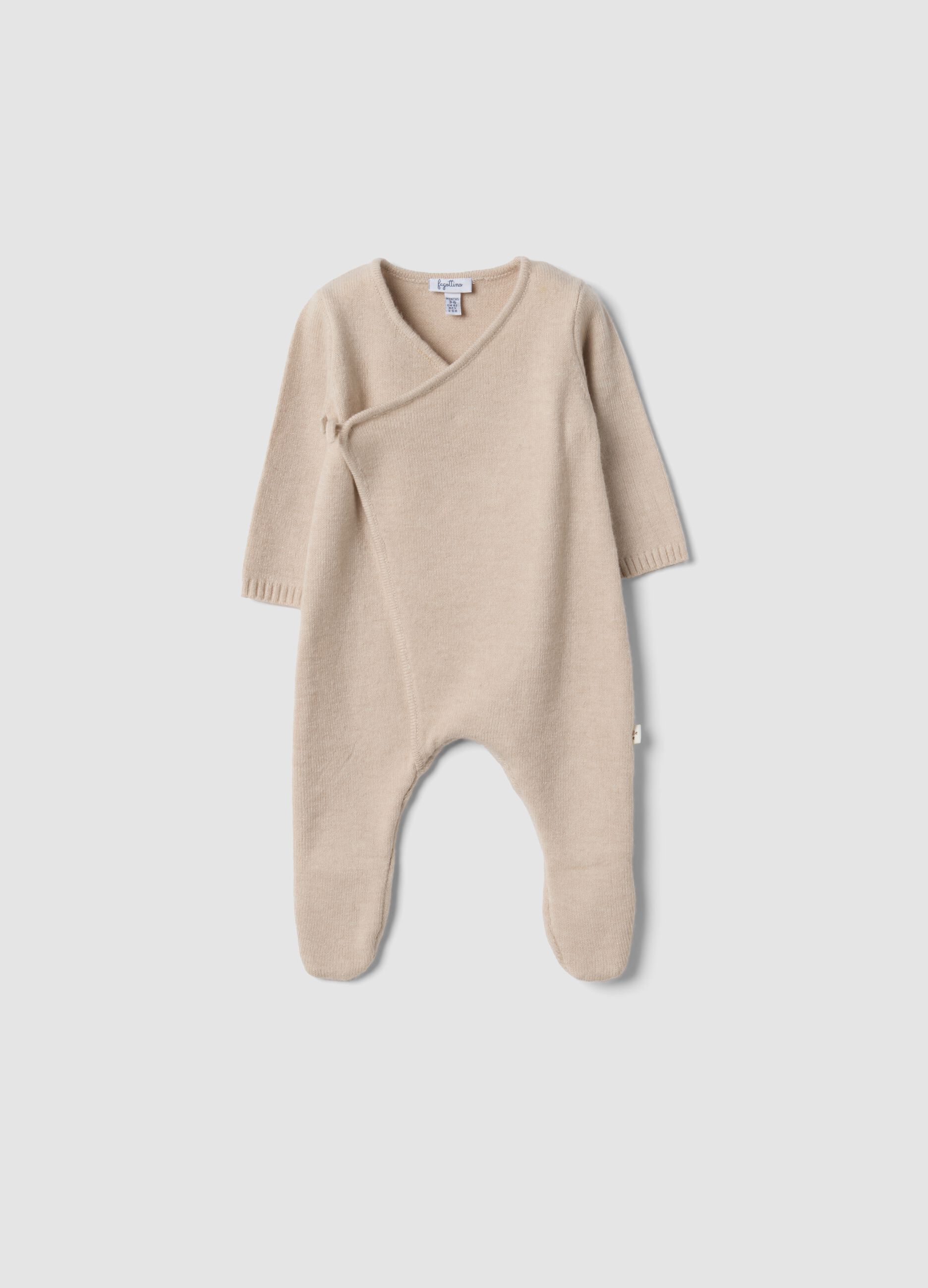 Beige baby sleepsuit with feet and wrap closure