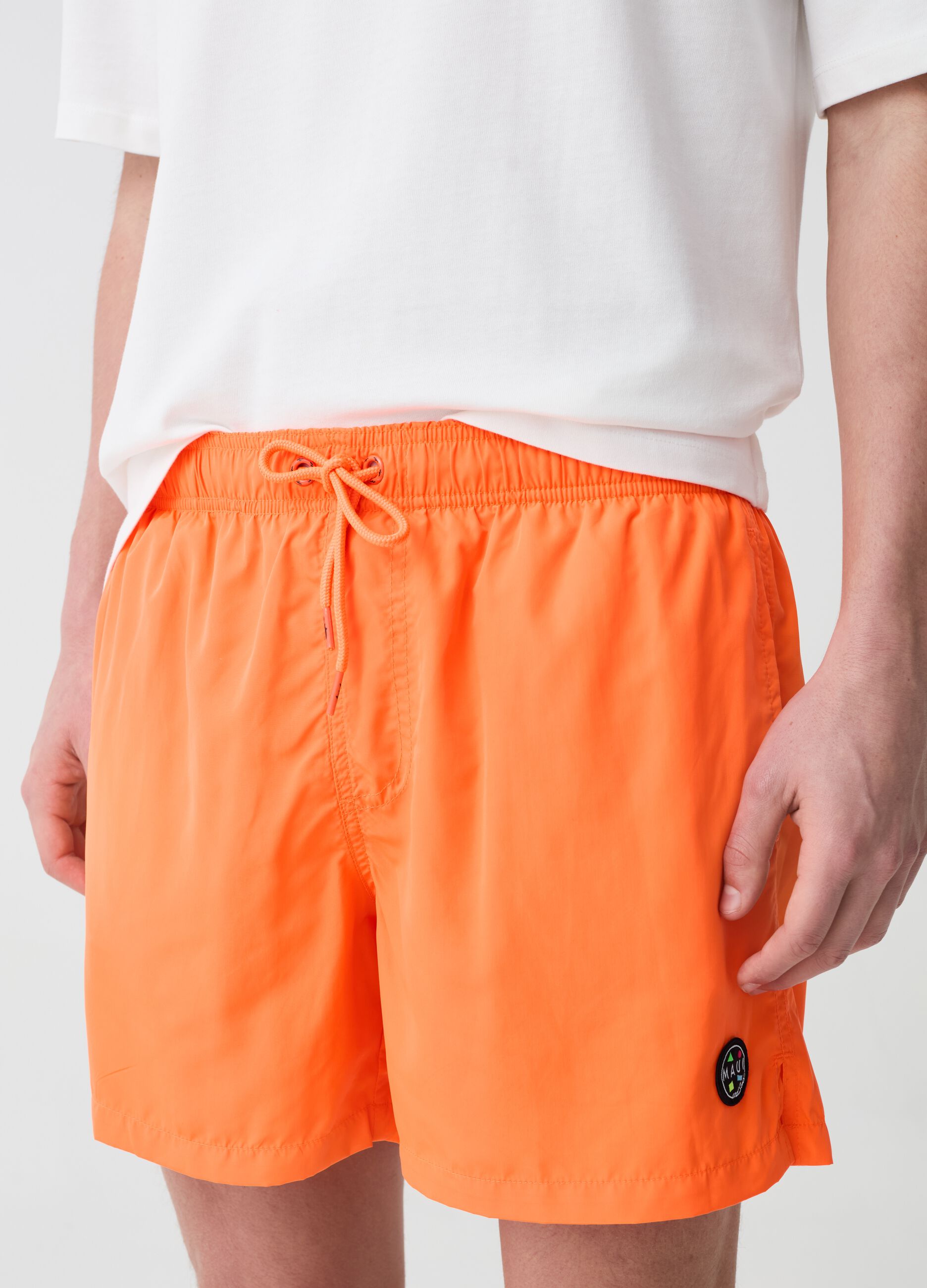 Fluorescent swimming trunks with logo patch