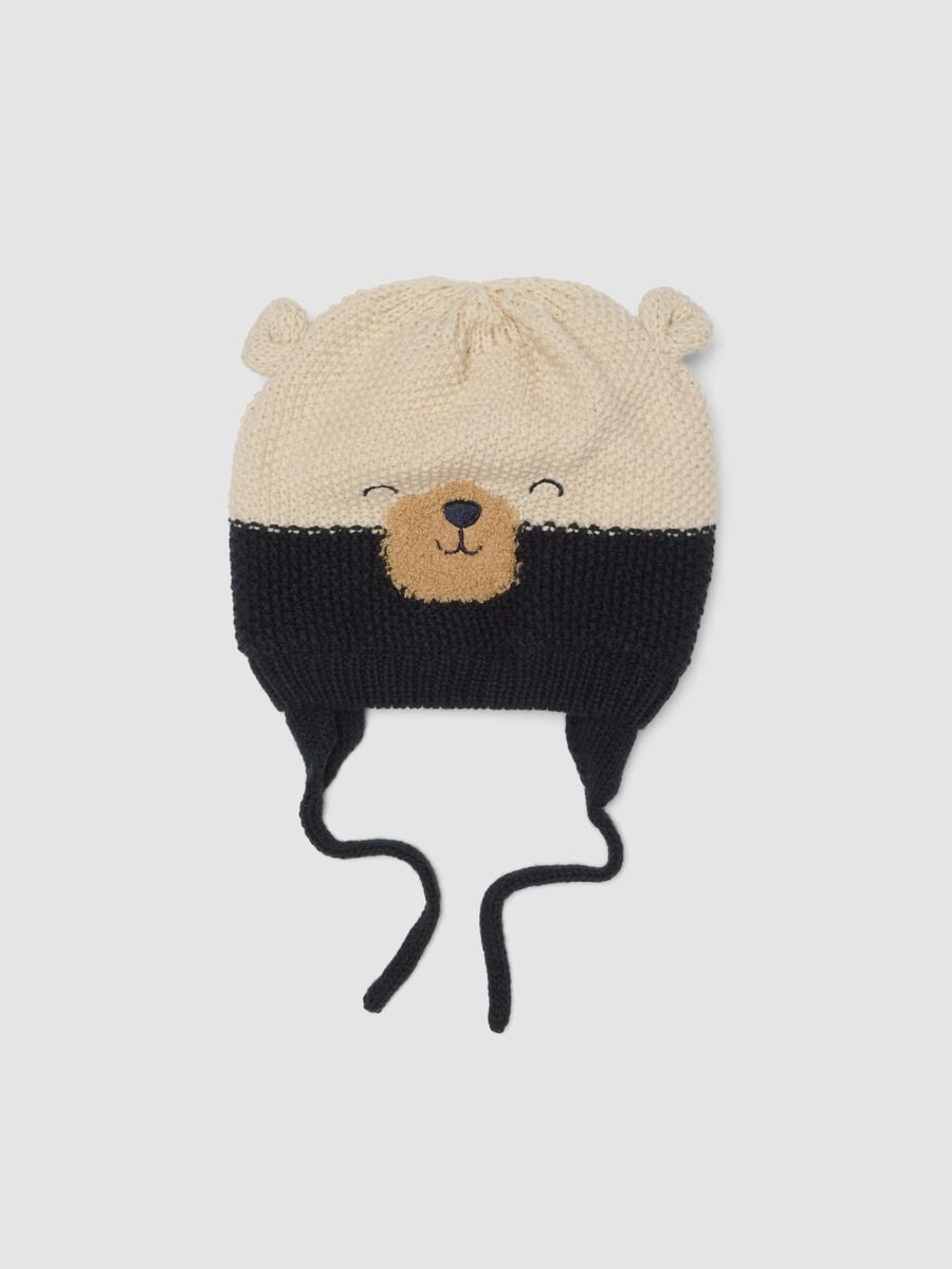 Blue knitted hat with teddy bear motif and ties_0