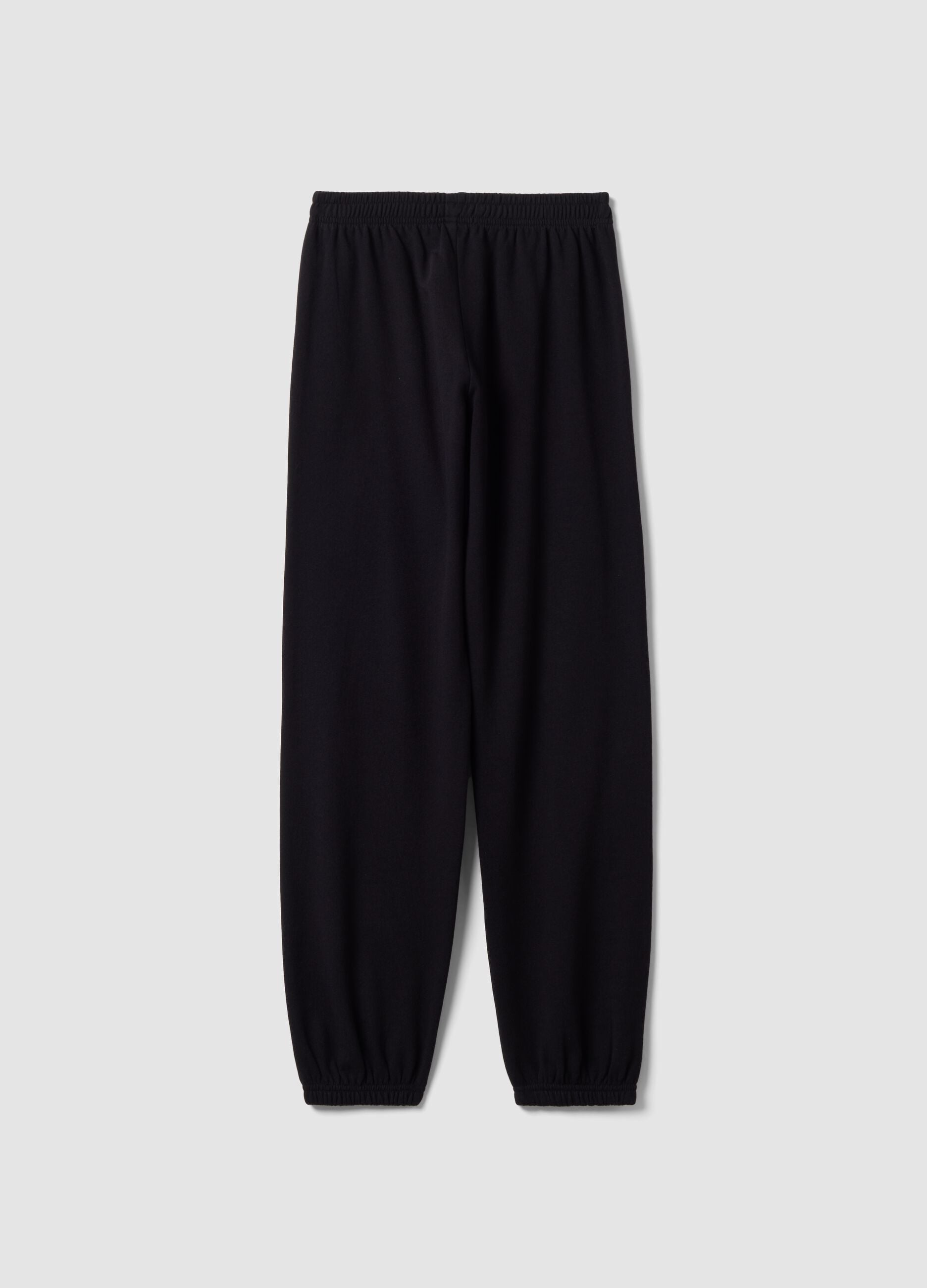 Cal&ccedil;as jogger pretas em mistura de algod&atilde;o org&acirc;nico com estampado para rapariga