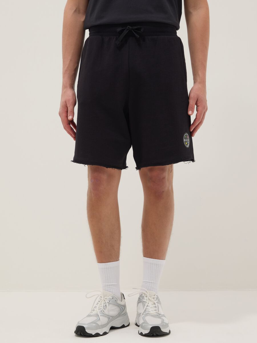Black pure cotton relaxed-fit Bermuda shorts with raw-cut hems_1