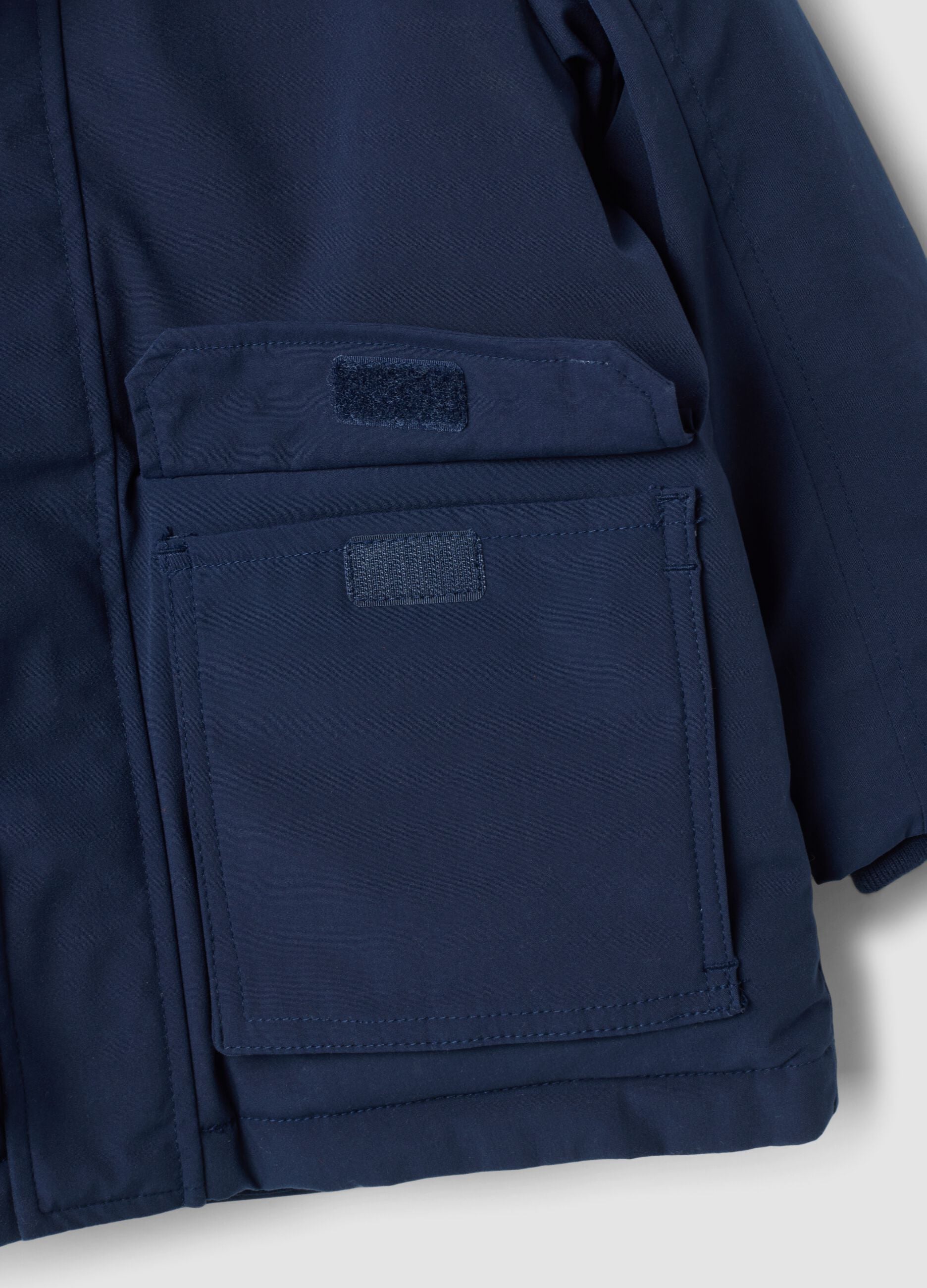 Long padded navy parka with detachable hood, oversized fit