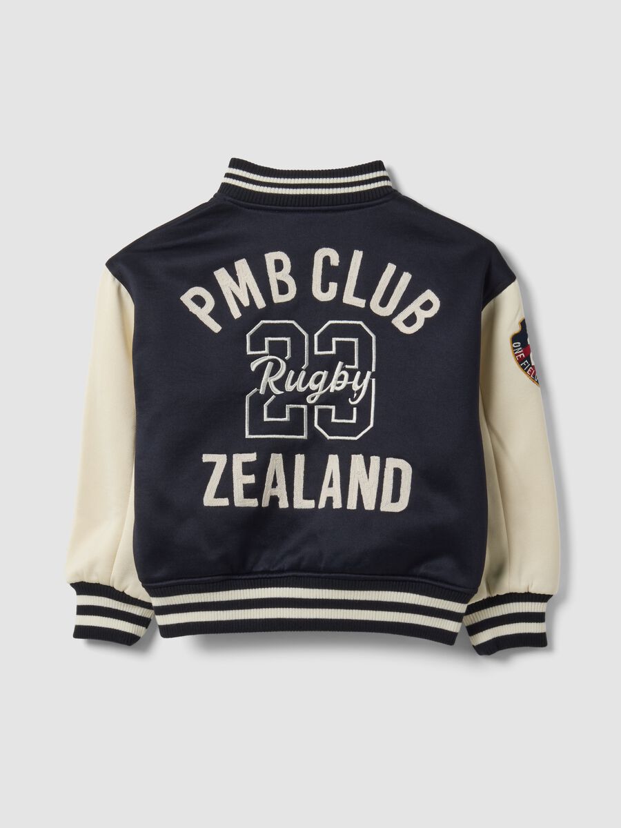 Blue varsity jacket with beige sleeves and print for boys_2