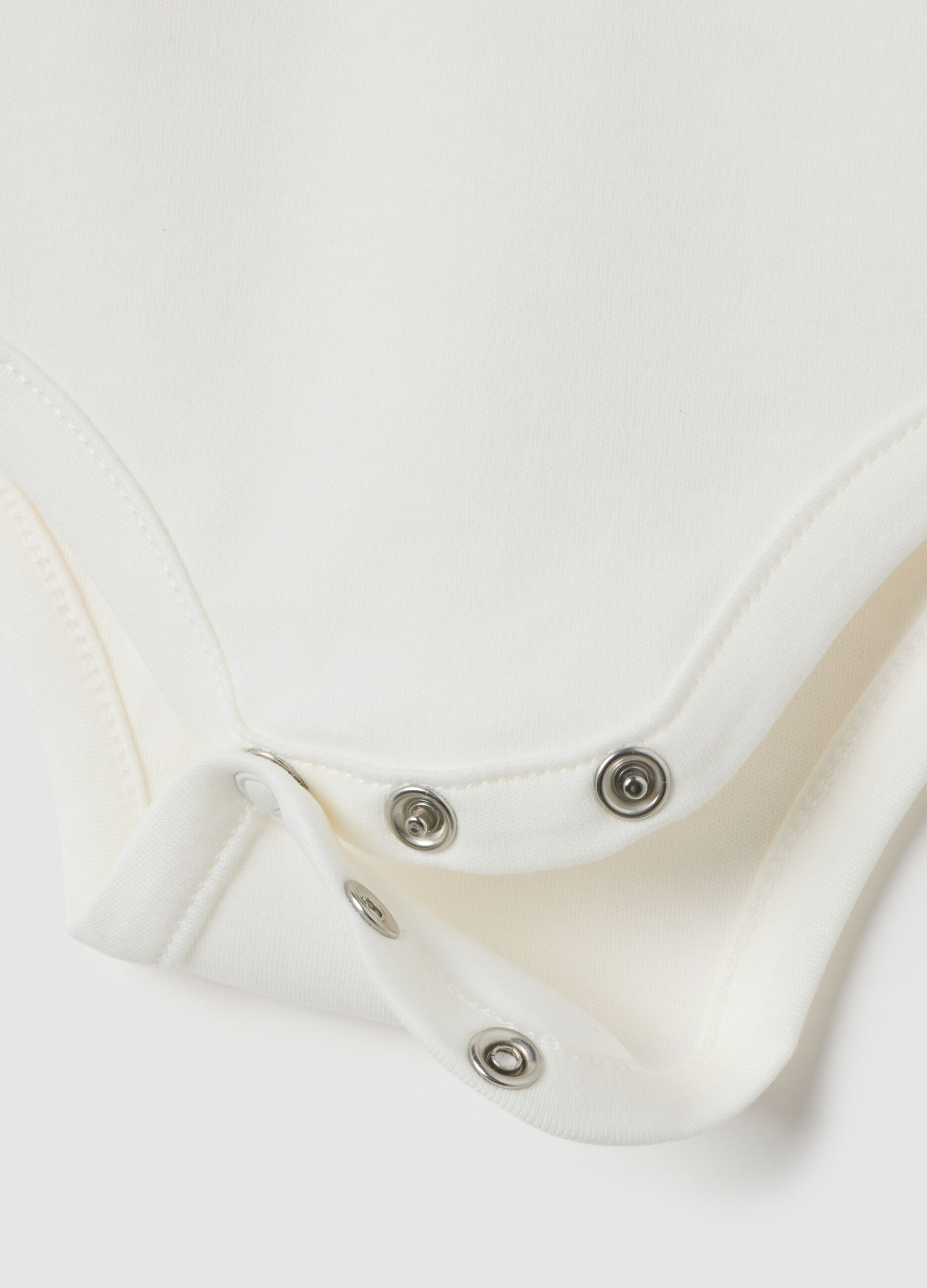 Newborn baby bodysuit in pure white cotton with ruffled collar