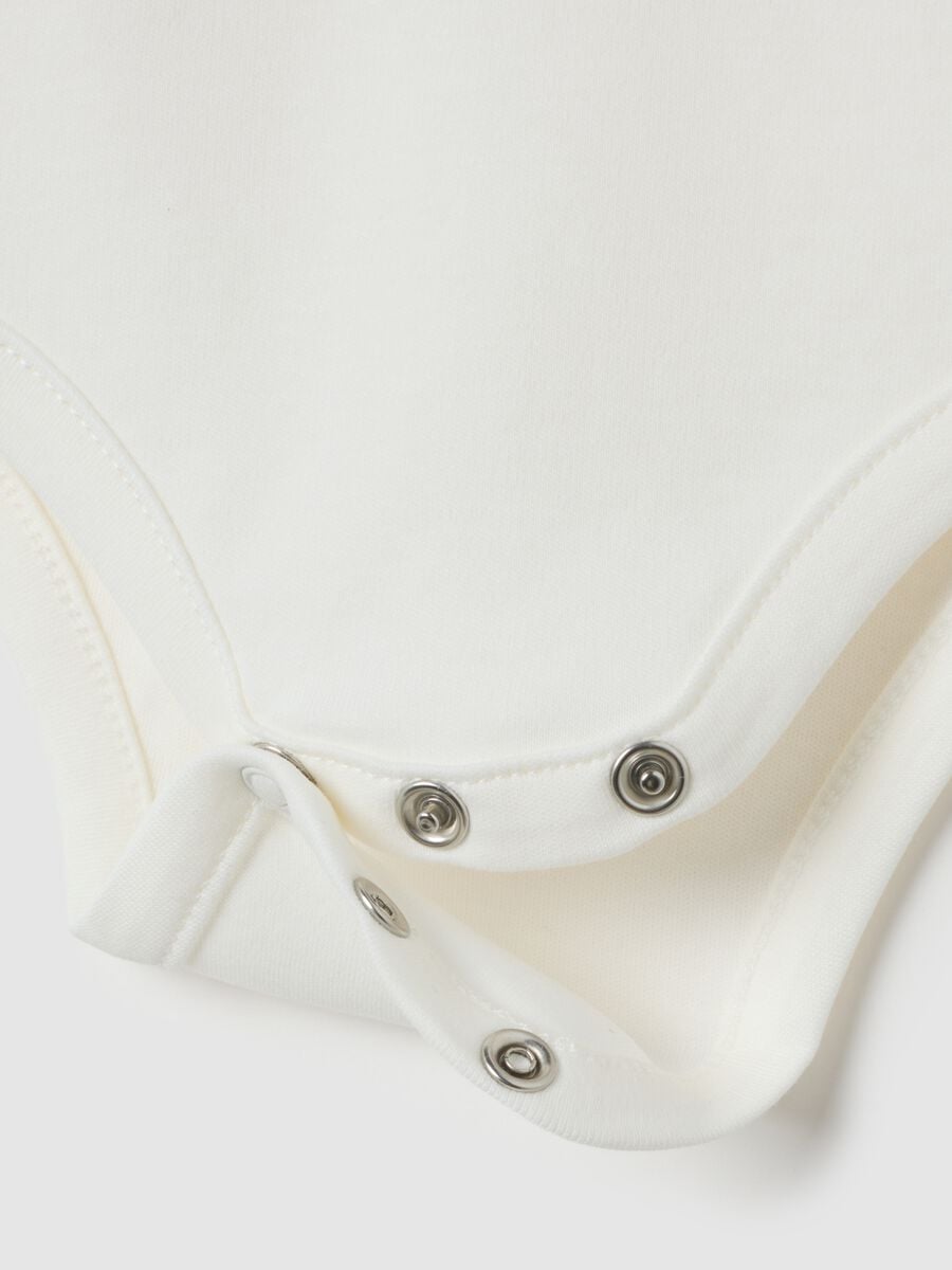 Newborn baby bodysuit in pure white cotton with ruffled collar_2