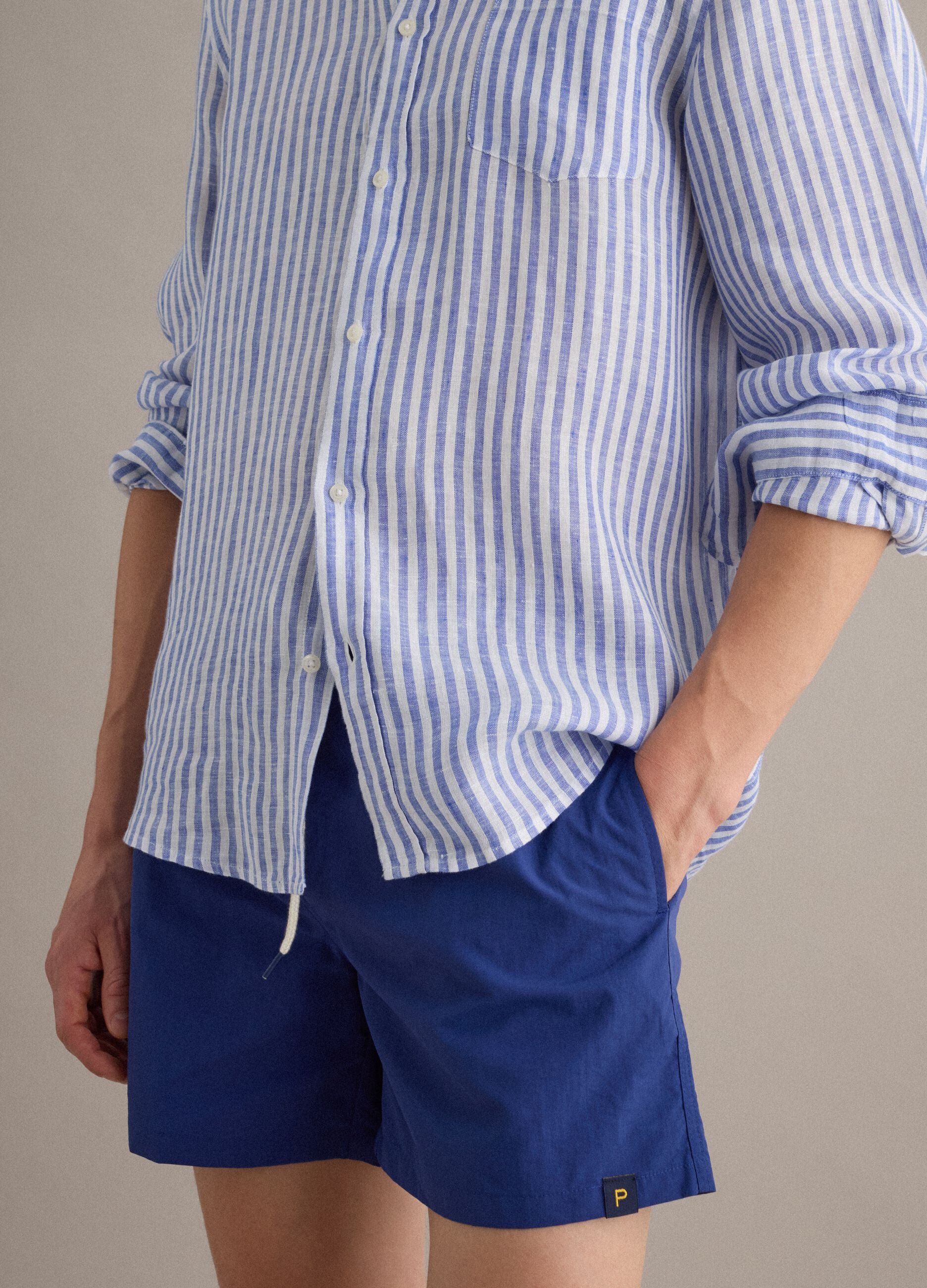Blue swim shorts with elasticated waist and drawstring