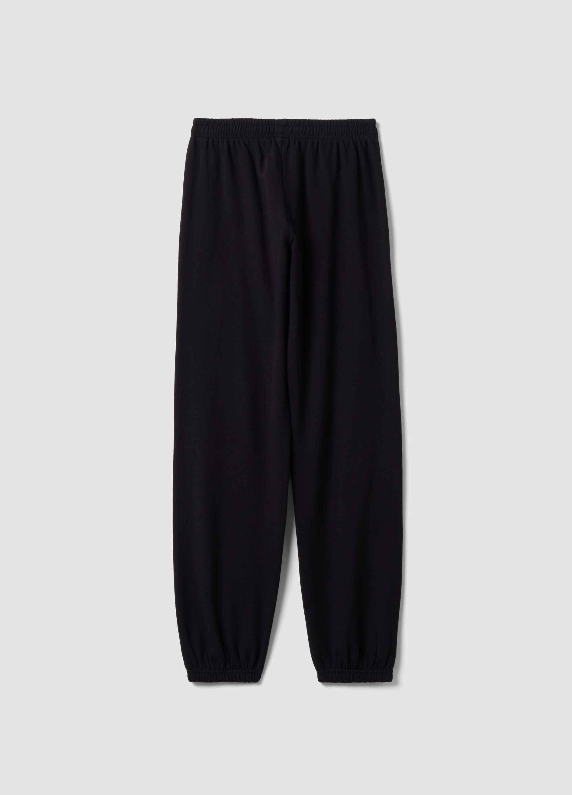 Cal&ccedil;as jogger pretas em mistura de algod&atilde;o org&acirc;nico com estampado para rapariga