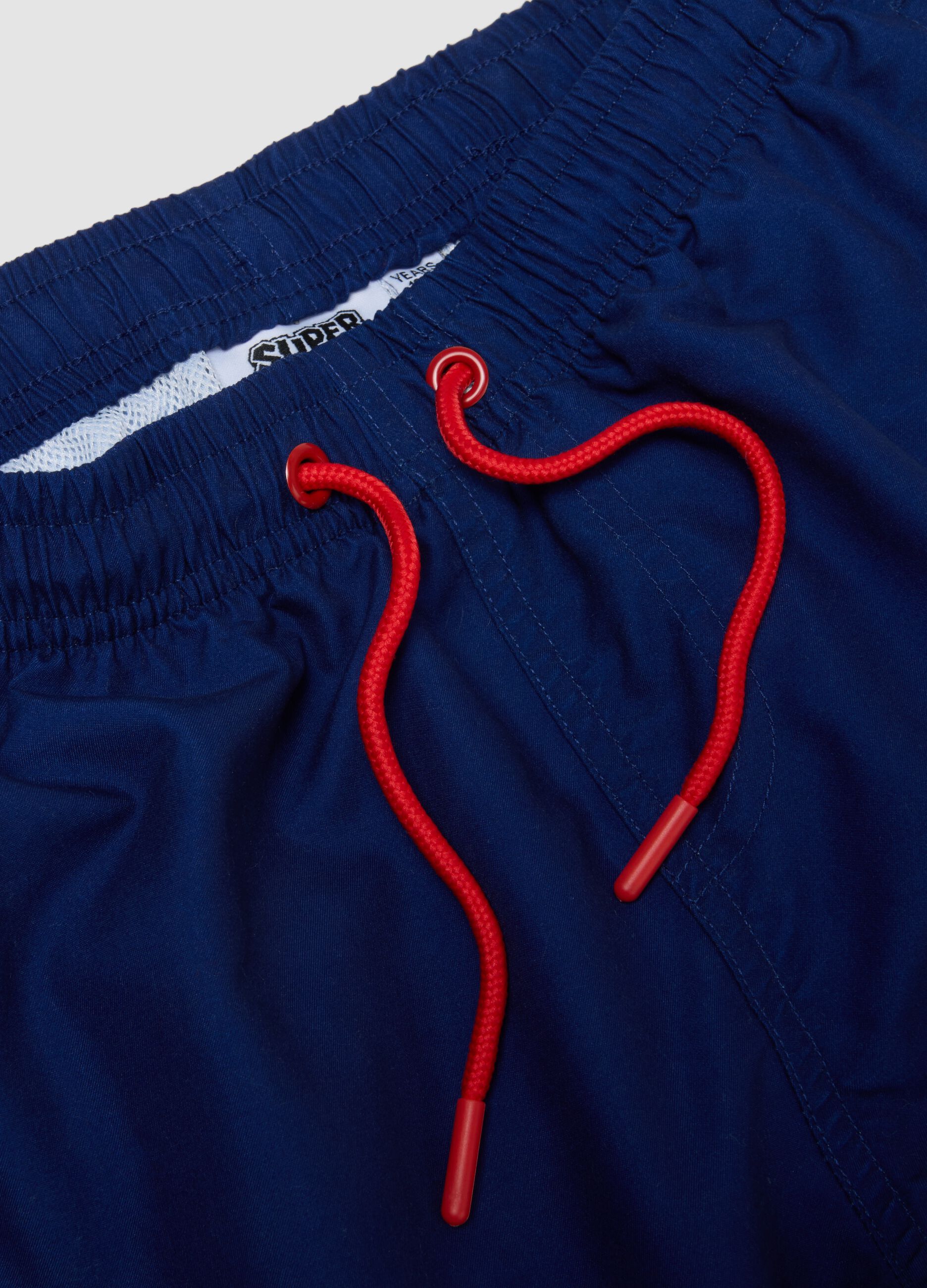 Blue regular fit swim trunks with Super Mario print