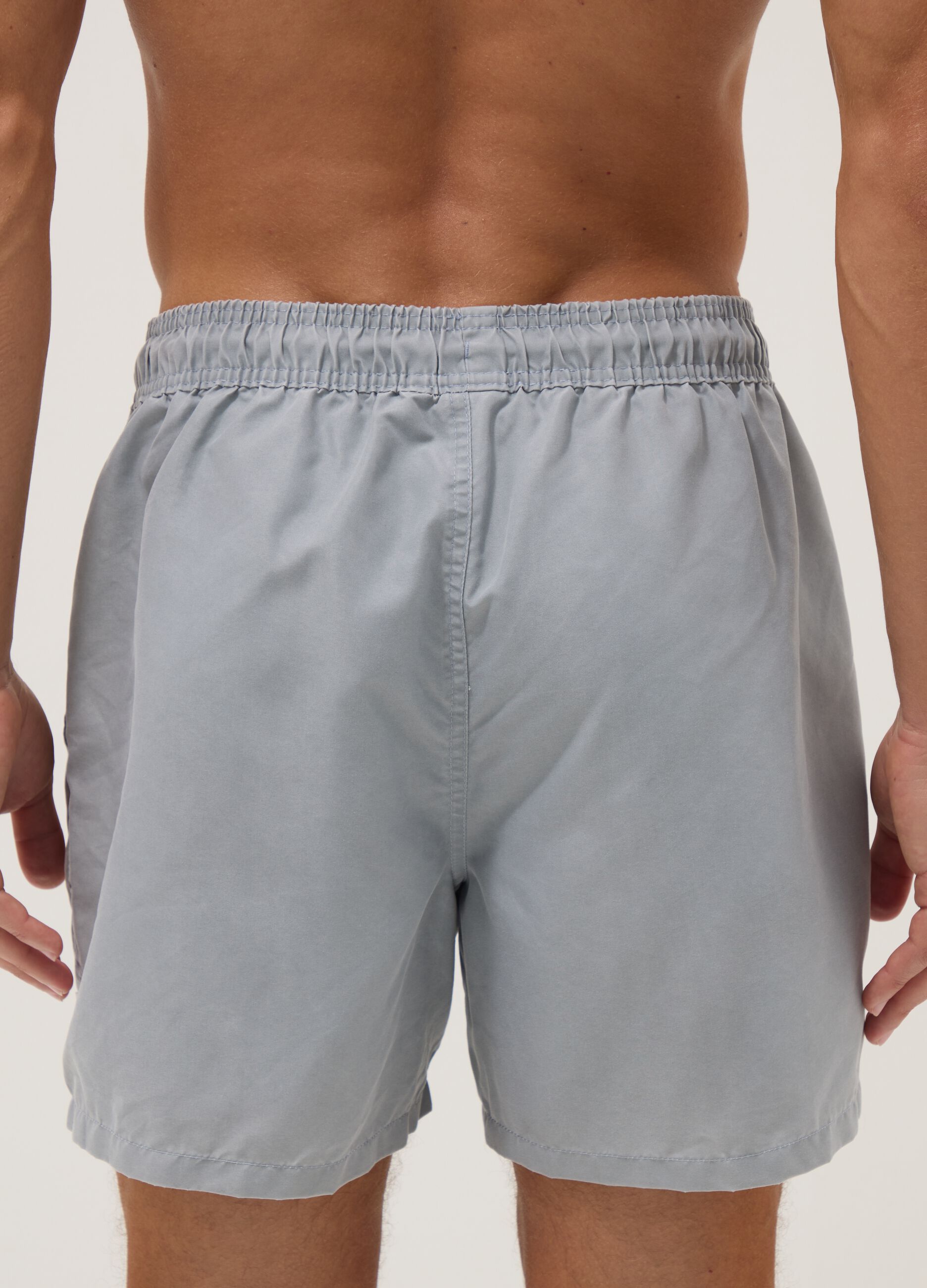 Blue swim shorts with drawstring waist
