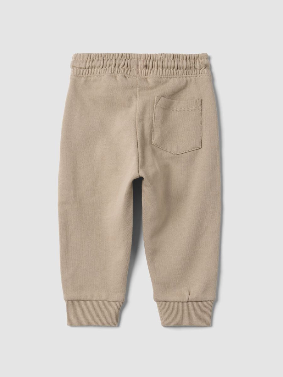 Pantaloni jogger beige in puro cotone con stampa cagnolino per bimbo_1