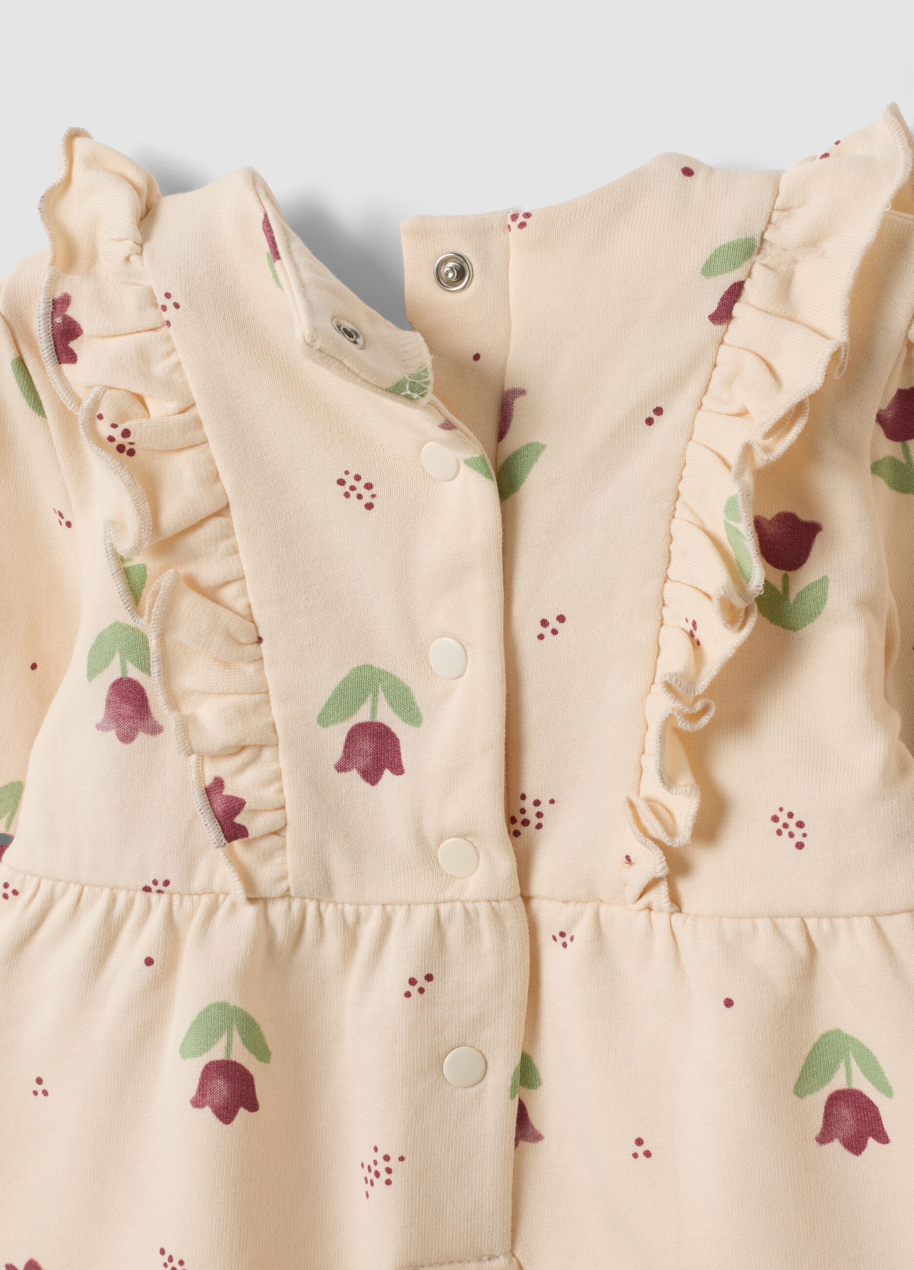 Tutina beige in puro cotone organico con stampa floreale per neonata